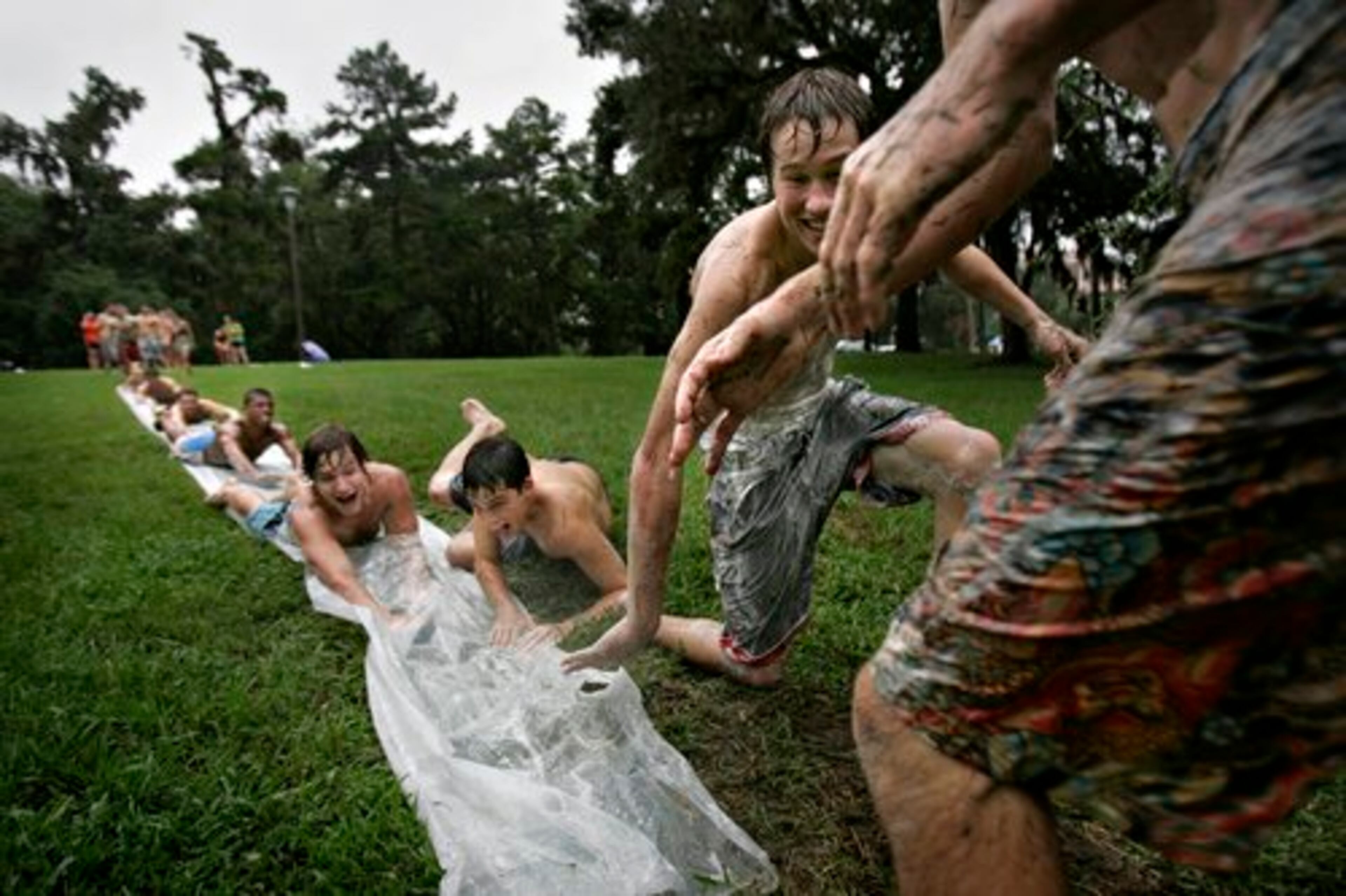 University of Florida students in Gainesville slide down a sheet of plastic covered in detergent Thursday.