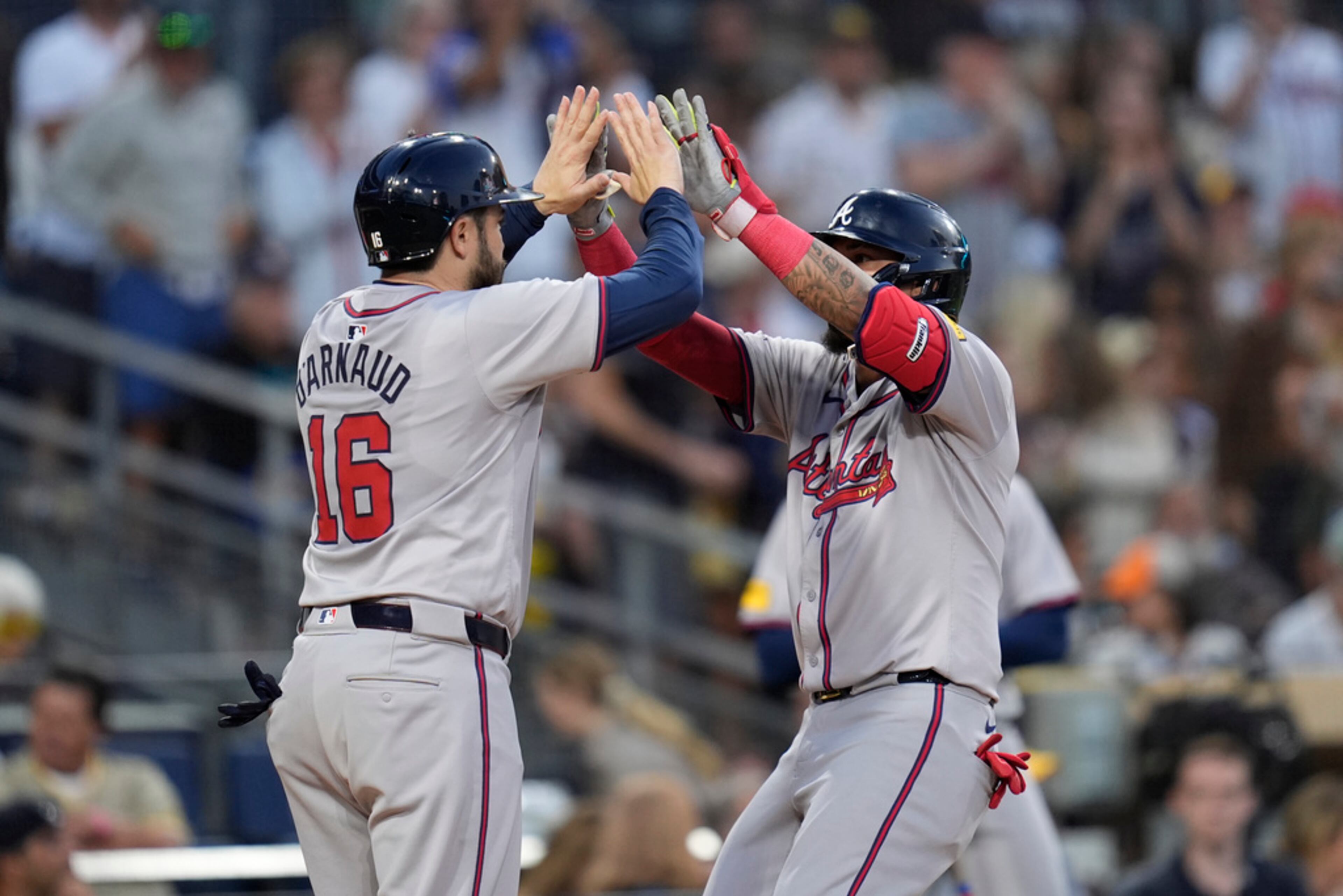 Atlanta Braves' Orlando Arcia, right, celebrates with teammate Travis d'Arnaud after hitting a two-run home run during the fifth inning of a baseball game against the San Diego Padres, Friday, July 12, 2024, in San Diego. (AP Photo/Gregory Bull)