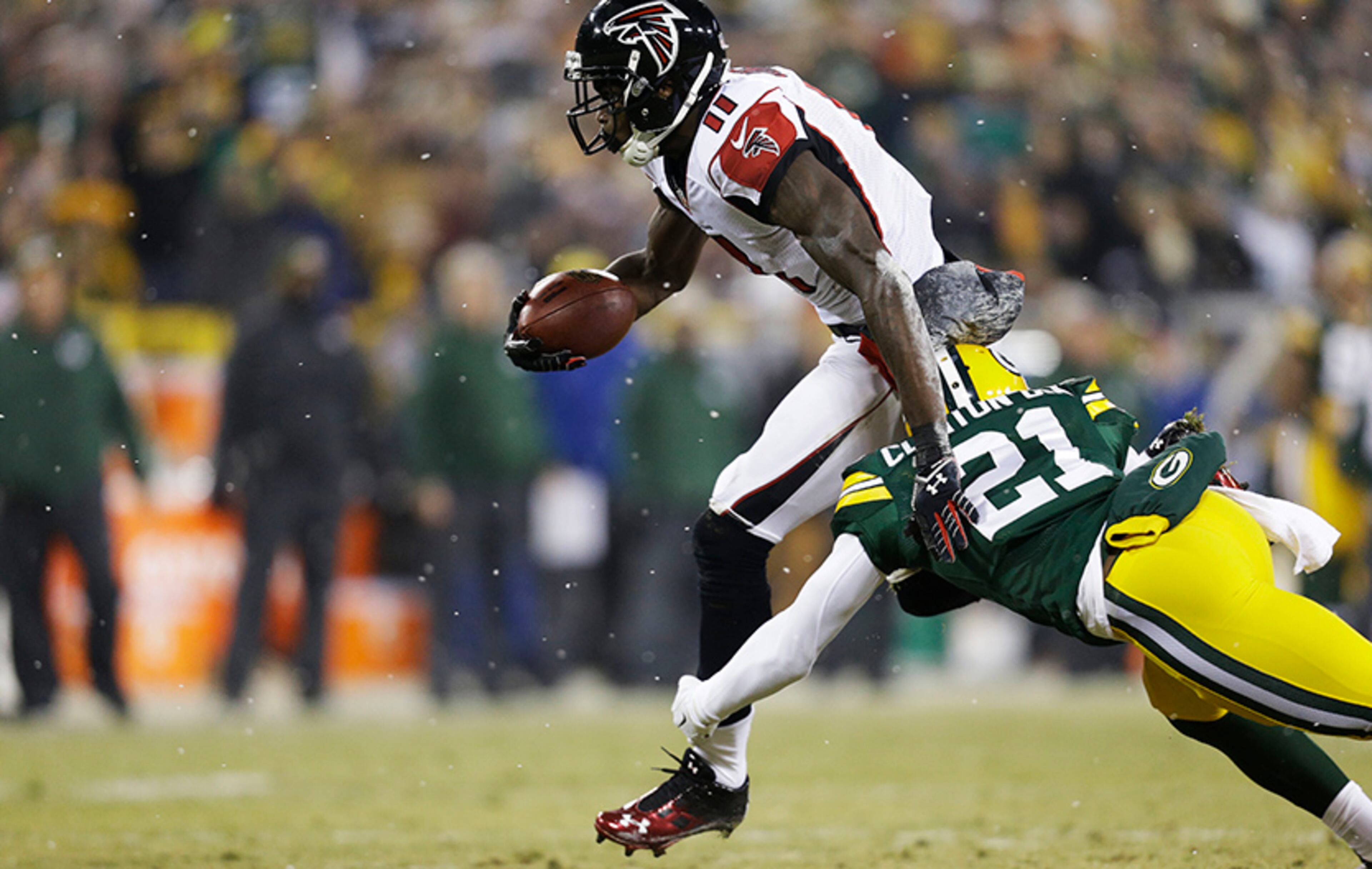 Falcons wide receiver Julio Jones takes a reception against the defense of Ha Ha Clinton-Dix for extra yards in the first quarter at Lambeau Field on Dec. 8, 2014, in Green Bay, Wis.