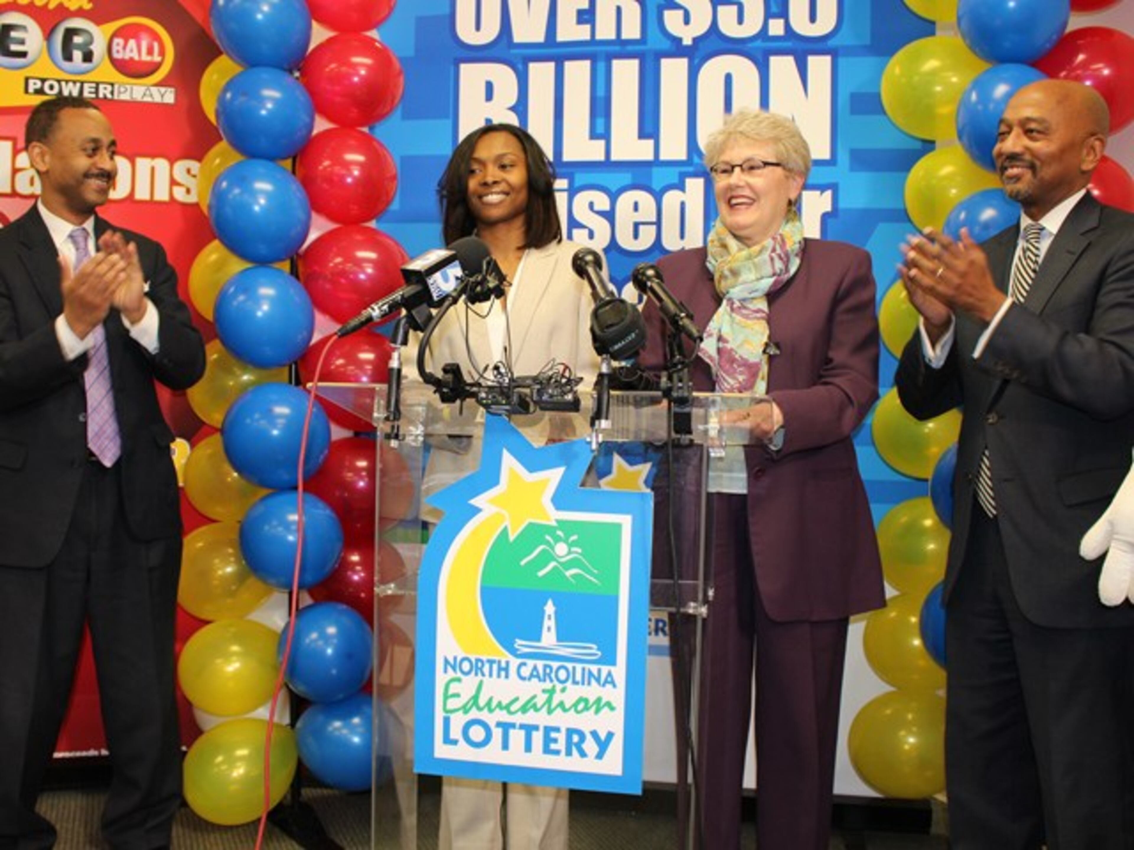 Marie Holmes (second from left) won $88 million (after taxes) in a Powerball drawing.