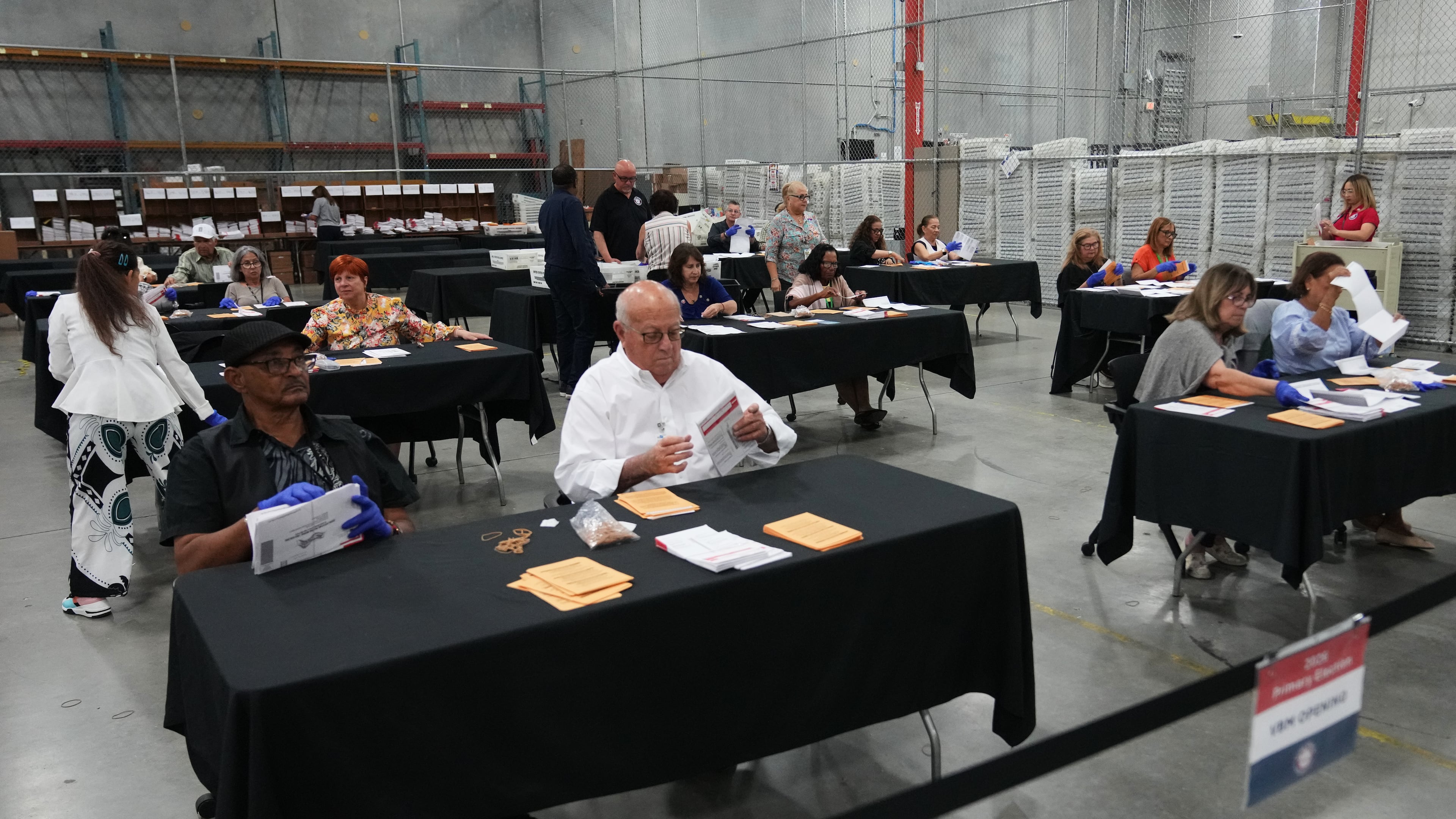 Election workers sort vote-by-mail ballots at the Miami-Dade County Supervisor of Elections Office for the Florida primary election in Doral, Fla., Tuesday, Aug. 18, 2026. (AP Photo/Lynne Sladky)