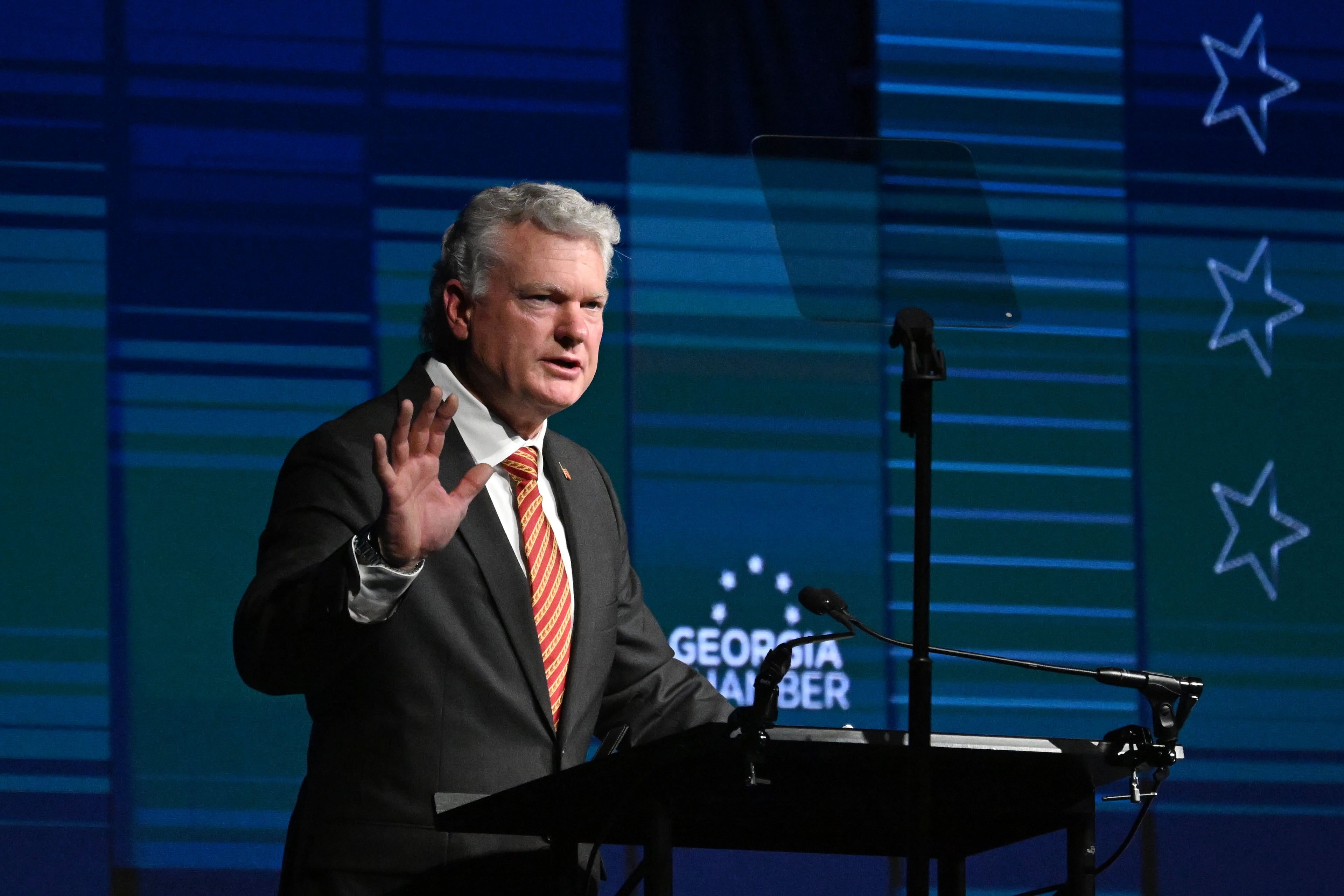 Republican U.S. Senate nominee Mike Collins speaks during the Georgia Chamber Congressional Luncheon at The Classic Center on Wednesday. Collins has sought to portray Democratic U.S. Sen. Jon Ossoff as a socialist, a charge Ossoff's camp dismissed as false. (Hyosub Shin/AJC)