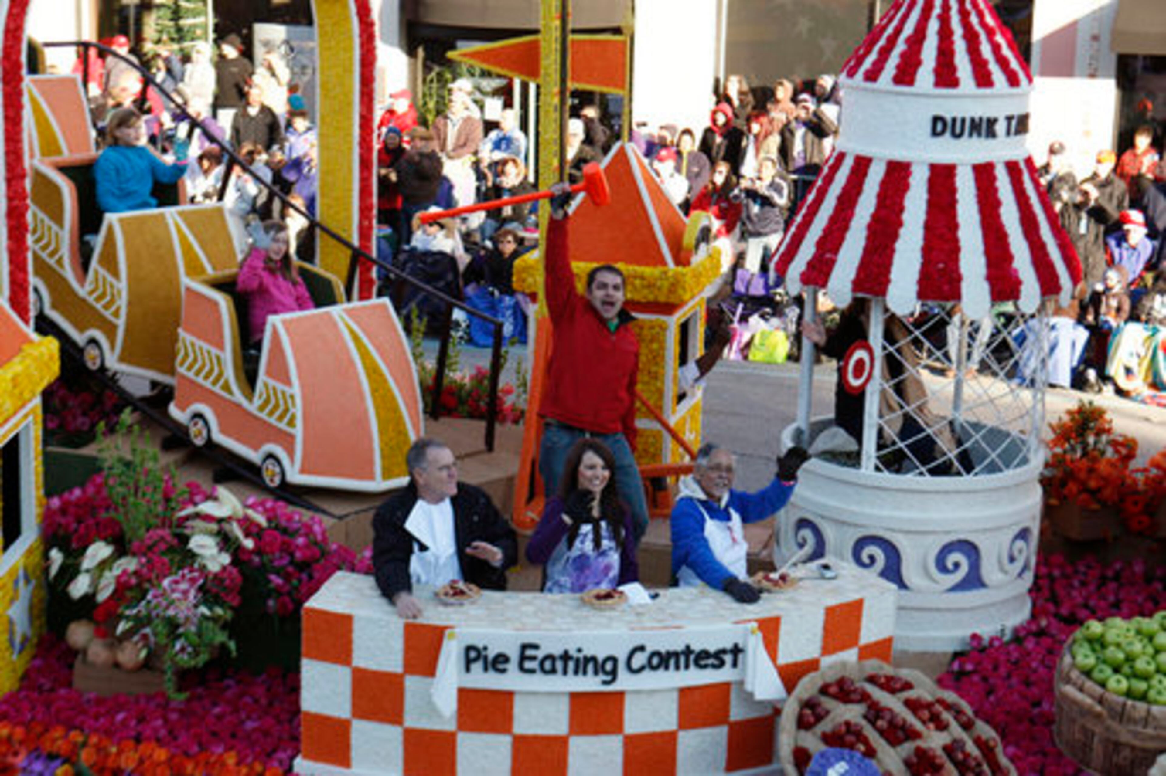 Members of the Discover Financial Services "A State Fair to Remember" float hold a pie eating contest during the parade.