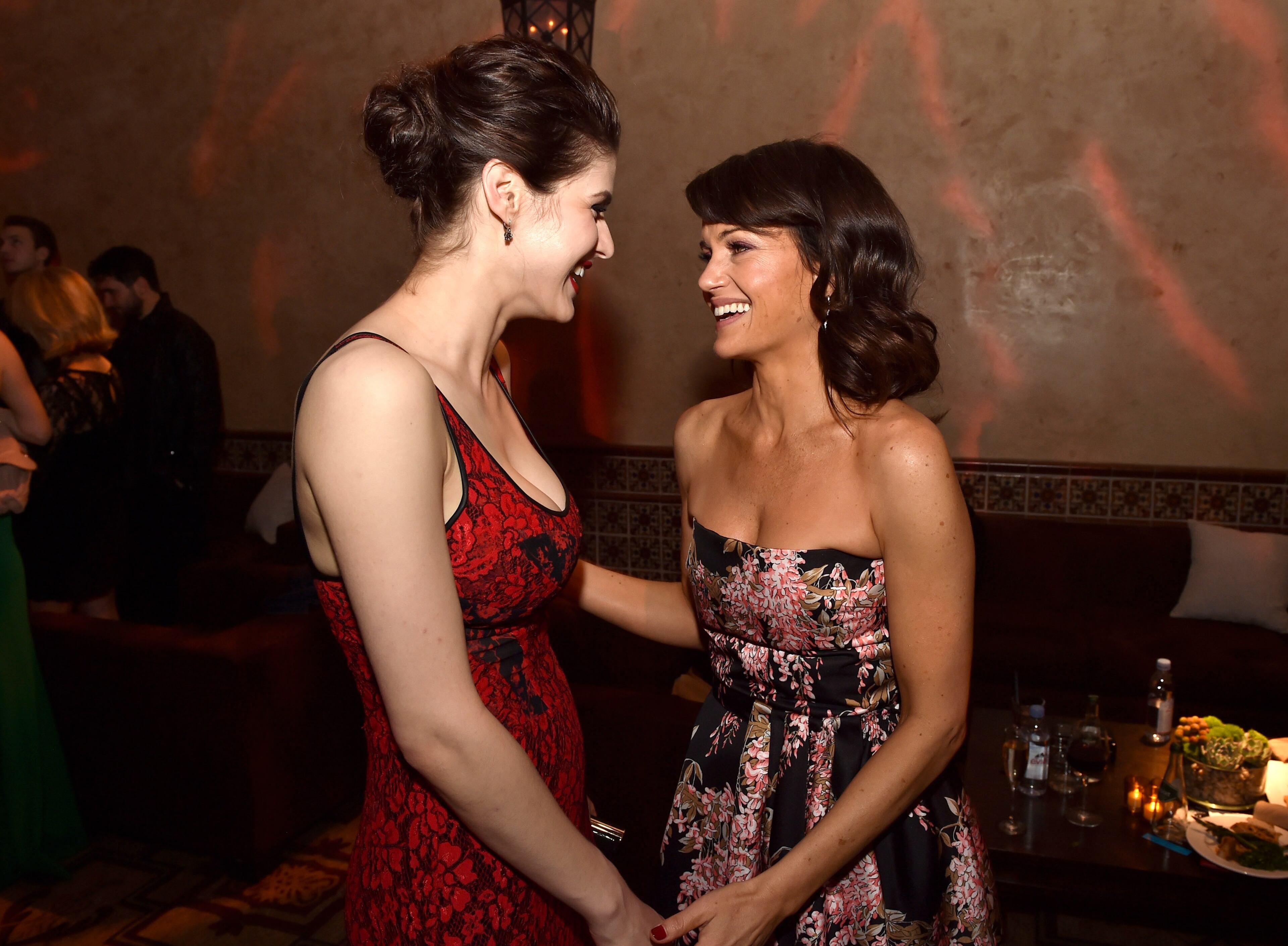 LOS ANGELES, CA - MAY 26: Actresses Alexandra Daddario (L) and Carla Gugino talk at the after party for the premiere of Warner Bros. Pictures' "San Andreas" at the Hollywood Roosevelt Hotel on May 26, 2015 in Los Angeles, California. (Photo by Kevin Winter/Getty Images)