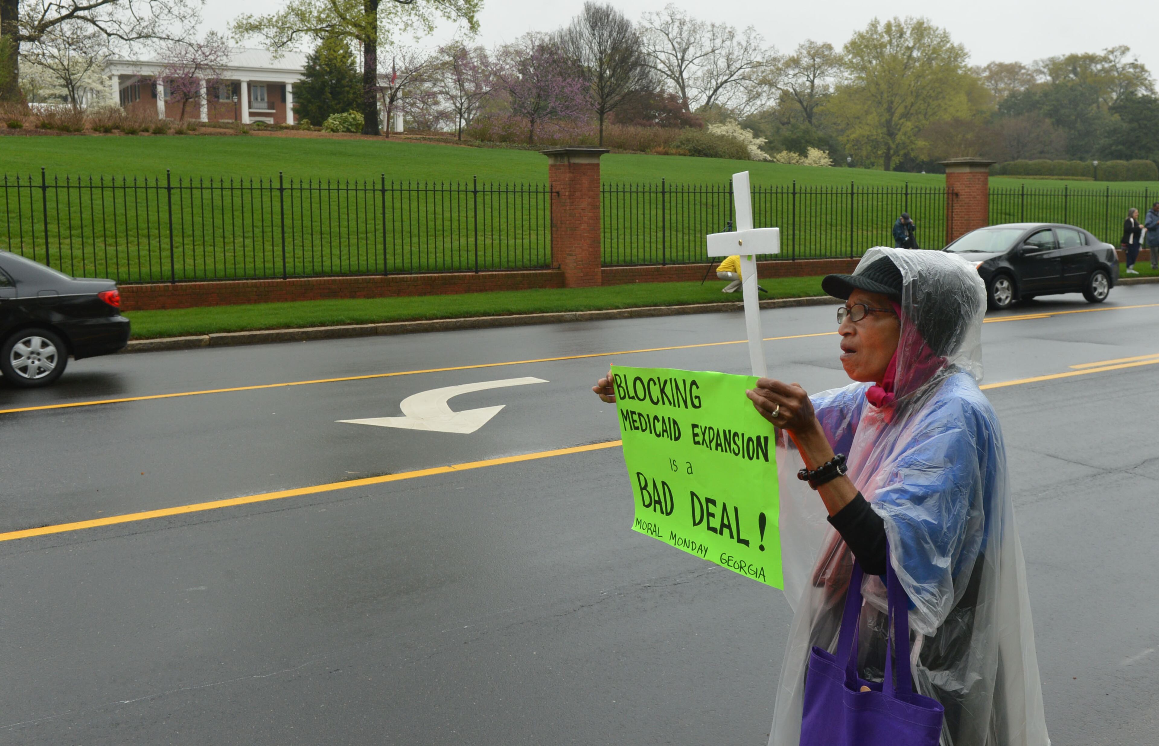 Bessie Sellaway of Atlanta joined the protest. About 75 protesters including several Atlanta clergy members and officials joined with Moral Monday in a Medicaid expansion protest outside the Governor's Mansion on W. Paces Ferry Road Monday, April 7, 2014. KENT D. JOHNSON / KDJOHNSON@AJC.COM