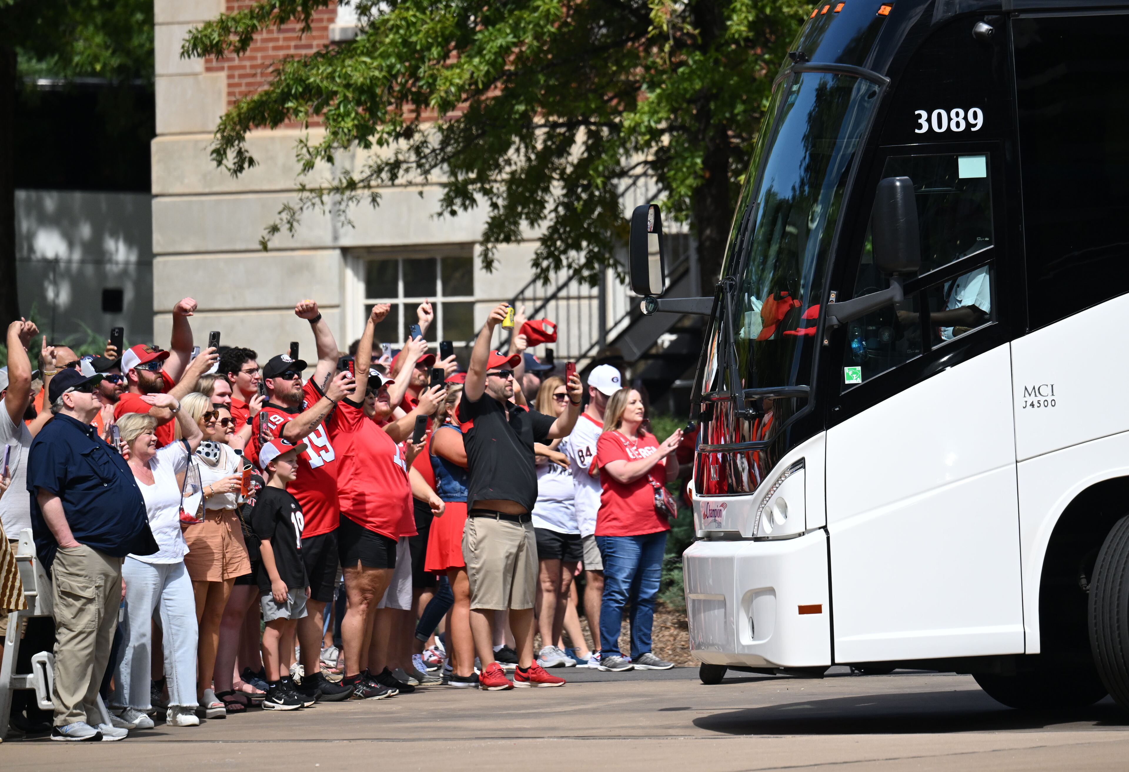 Georgia fans cheer as players and coaching staff arrive before their game against Auburn at Jordan-Hare Stadium, Saturday, Sept. 30, 2023, in Auburn, Alabama. (Hyosub Shin / Hyosub.Shin@ajc.com)