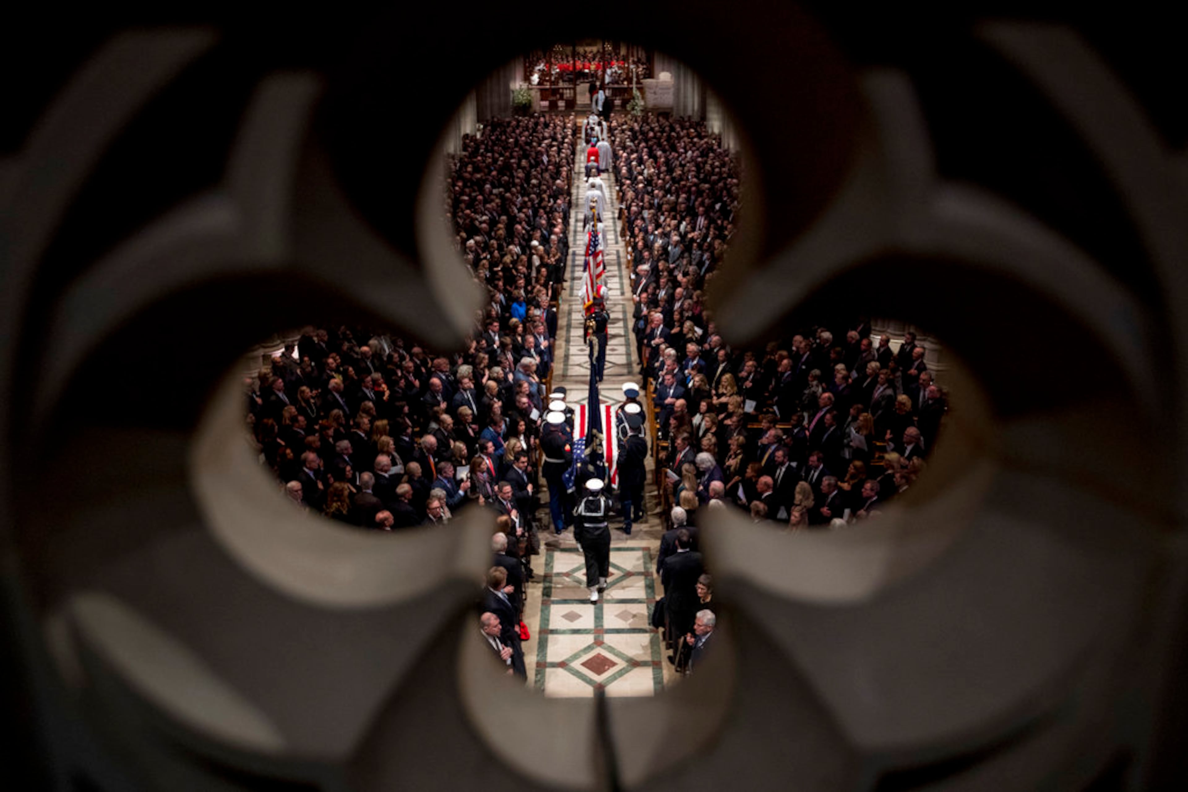 The flag-draped casket of former President George H.W. Bush is carried by a military honor guard into a State Funeral at the National Cathedral, Wednesday, Dec. 5, 2018, in Washington. (AP Photo/Andrew Harnik, Pool)