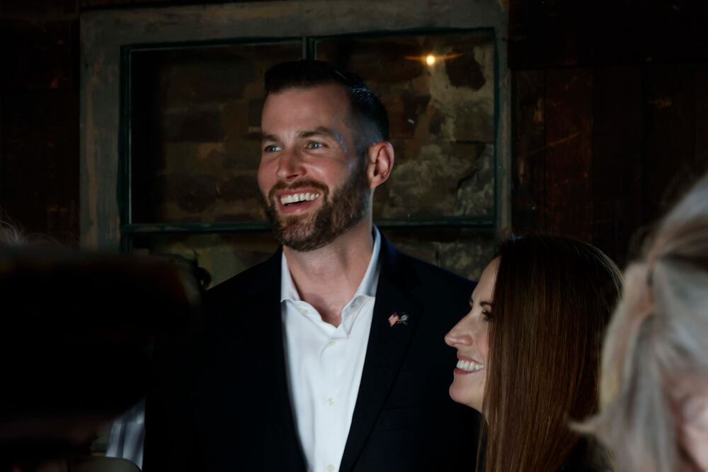 Clay Fuller and his wife, Kate Fuller, smile as they talk with supporters at his runoff election watch party at the Historic Ringgold Depot on Tuesday, April 7, 2026. (Miguel Martinez/AJC)