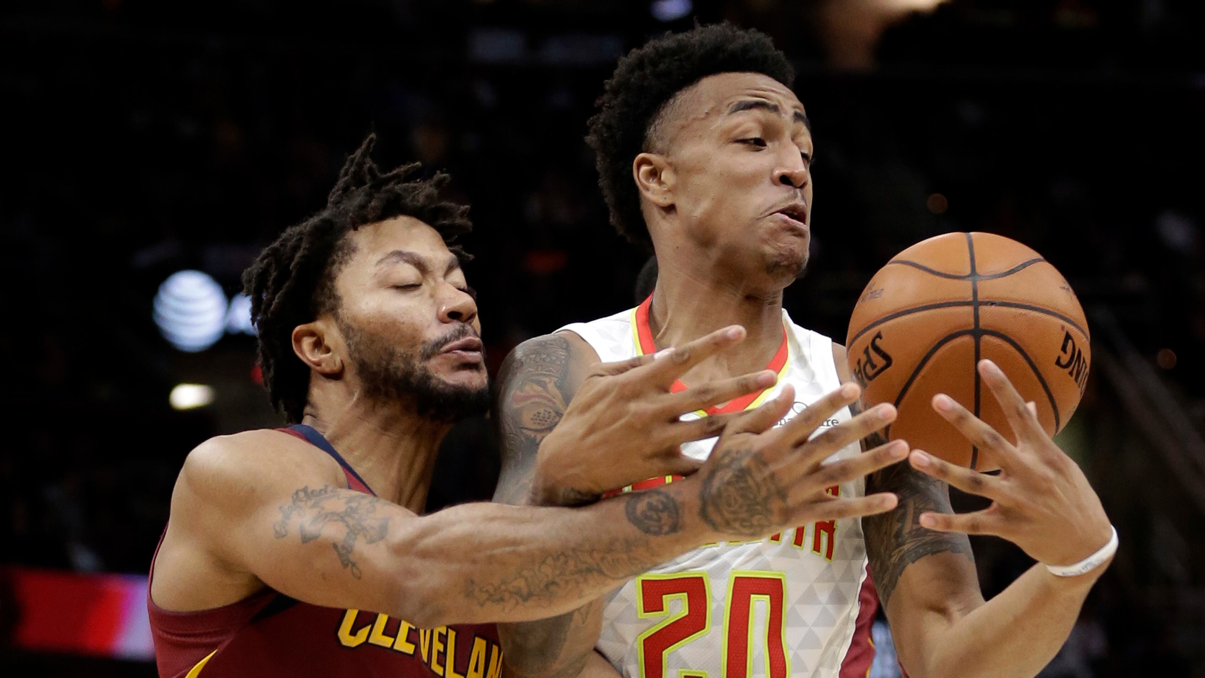 Atlanta Hawks' John Collins (20) and Cleveland Cavaliers' Derrick Rose (1) battle for the ball in the first half of an NBA basketball game Sunday, Nov. 5, 2017, in Cleveland. (AP Photo/Tony Dejak)