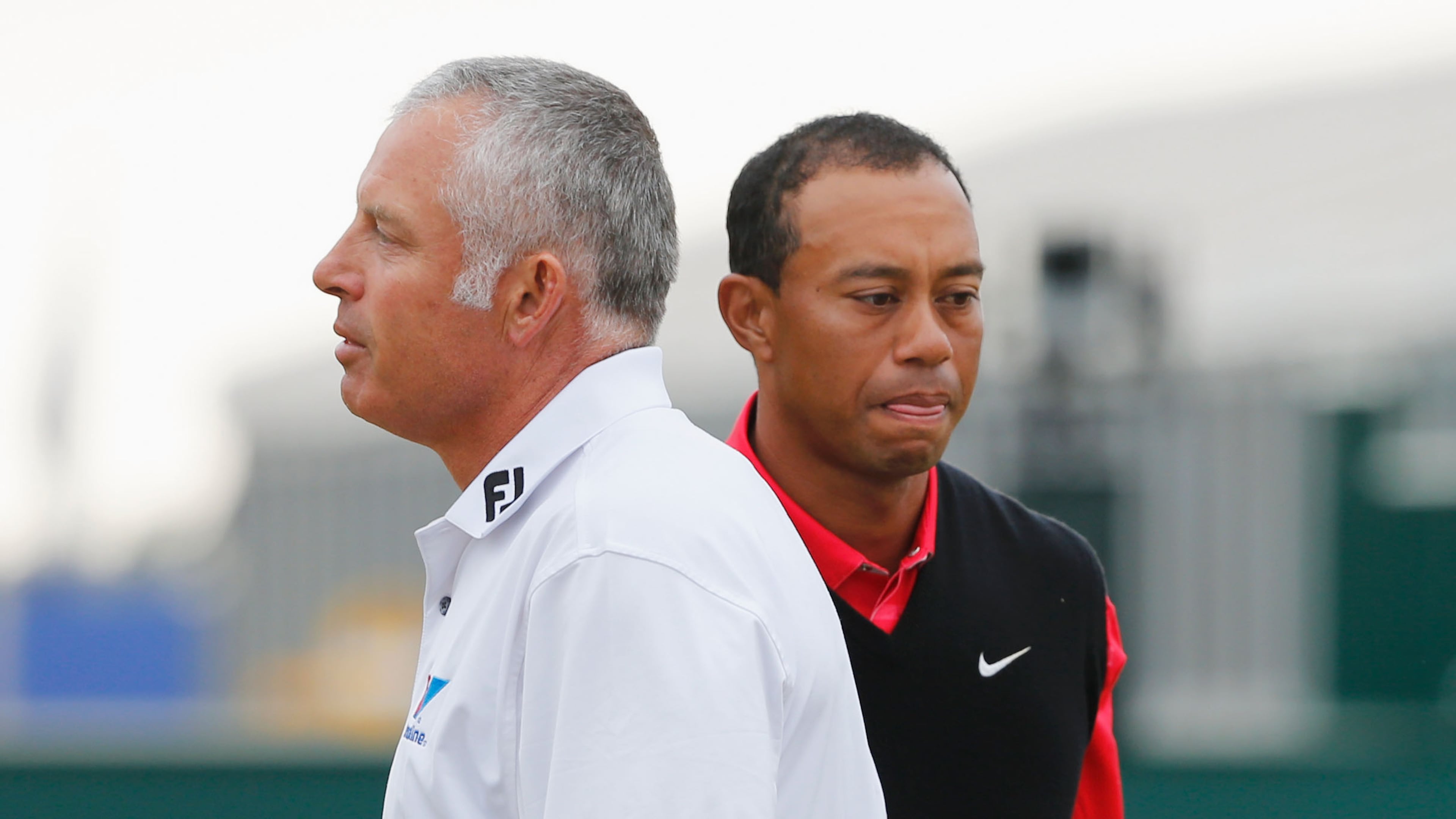 GULLANE, SCOTLAND - JULY 21: Tiger Woods of the United States shakes hands with Steve Williams the caddie of Adam Scott on the 18th green during the final round of the 142nd Open Championship at Muirfield on July 21, 2013 in Gullane, Scotland. (Photo by Rob Carr/Getty Images)