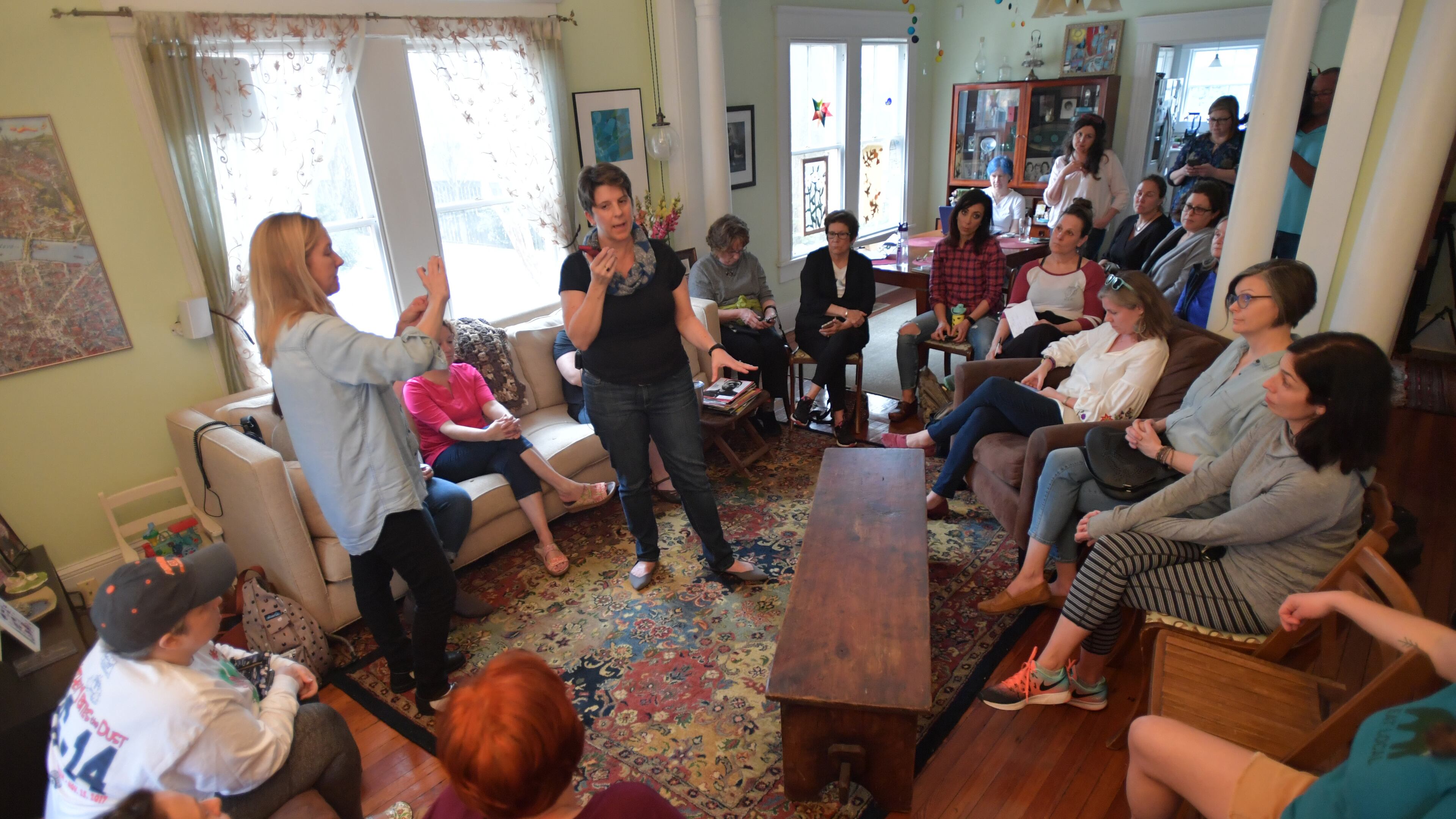 Clare Schexnyder leads a meeting as she goes live on her private Facebook page "Stop School Shootings" while about 30 supporters gather at Schexnyder's home in Decatur on Friday. Clare Shexnyder, a Decatur woman, started a private Facebook page Wednesday trying to organize nationally to do something about gun violence in school. HYOSUB SHIN / HSHIN@AJC.COM