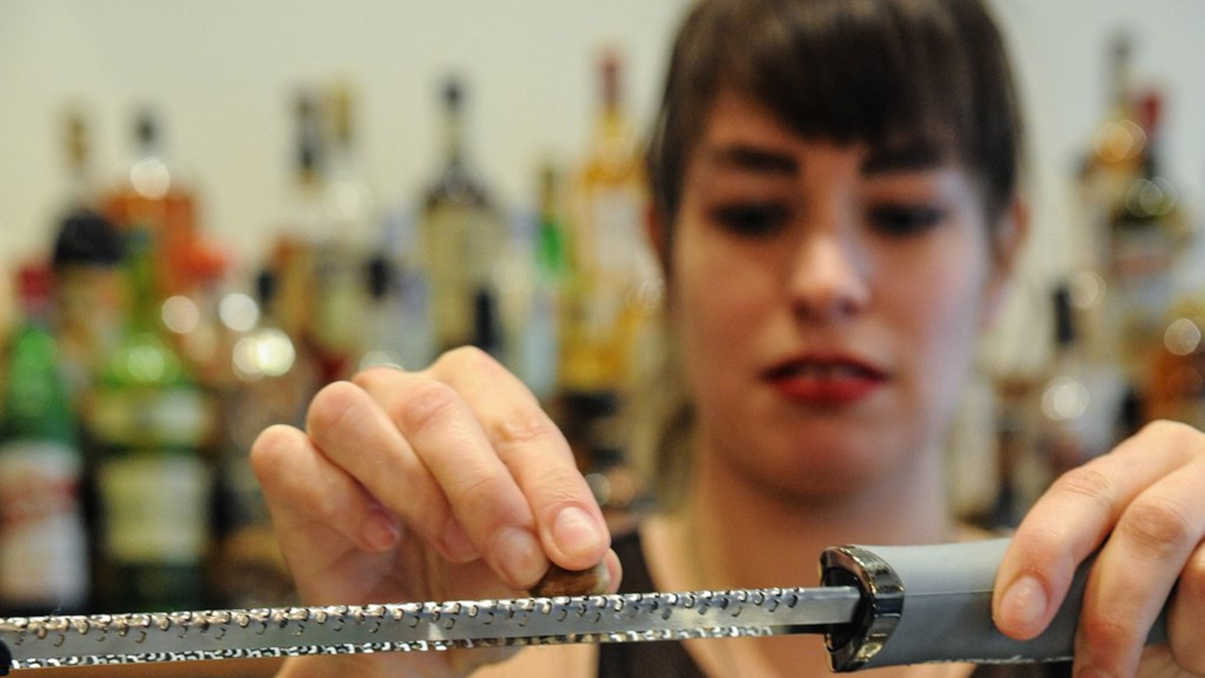 Bar Manager Shanna Mayo finishes the Smoke & Chill cocktail with mezcal, pineapple, banana, cinnamon, lime, Angostura bitters, nutmeg and mint at Amer in Inman Park. (Beckysteinphotography.com)