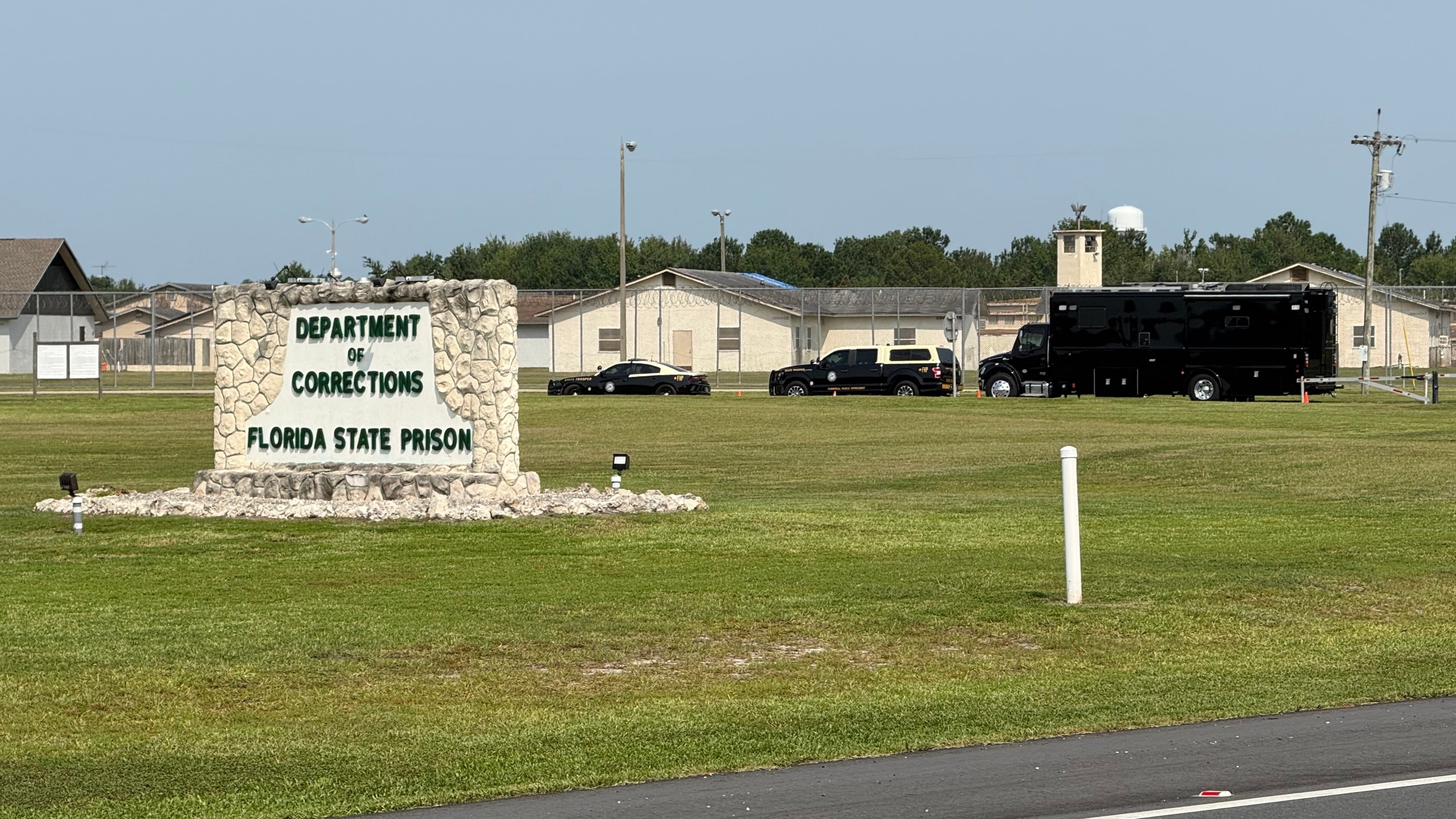 FILE - Law enforcement vehicles sit parked outside the Florida state prison in Starke, Fla., on Tuesday, July 28, 2026. (AP Photo/David Fischer, file)
