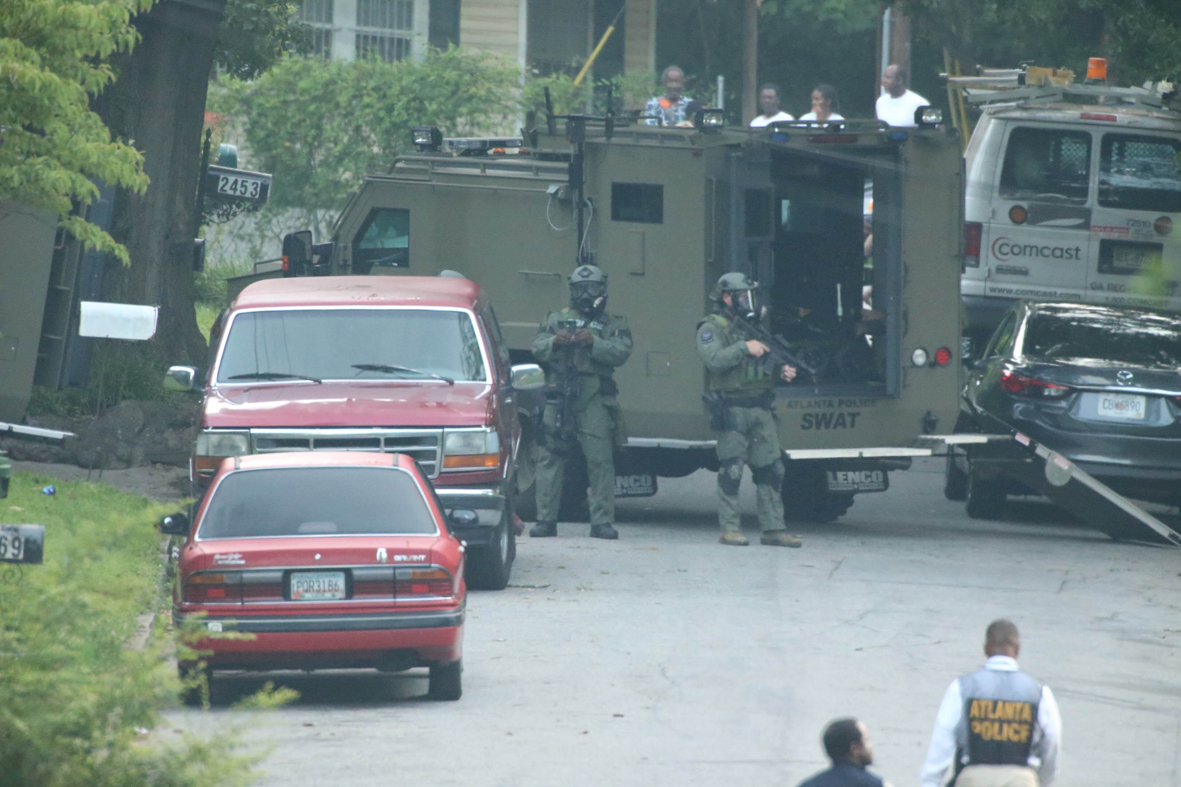 Atlanta police surrounded a home in southwest Atlanta for several hours early today, but when SWAT officers went into the house, the person whey were looking for was not there. JOHN SPINK/JOHNSPINK@AJC.COM