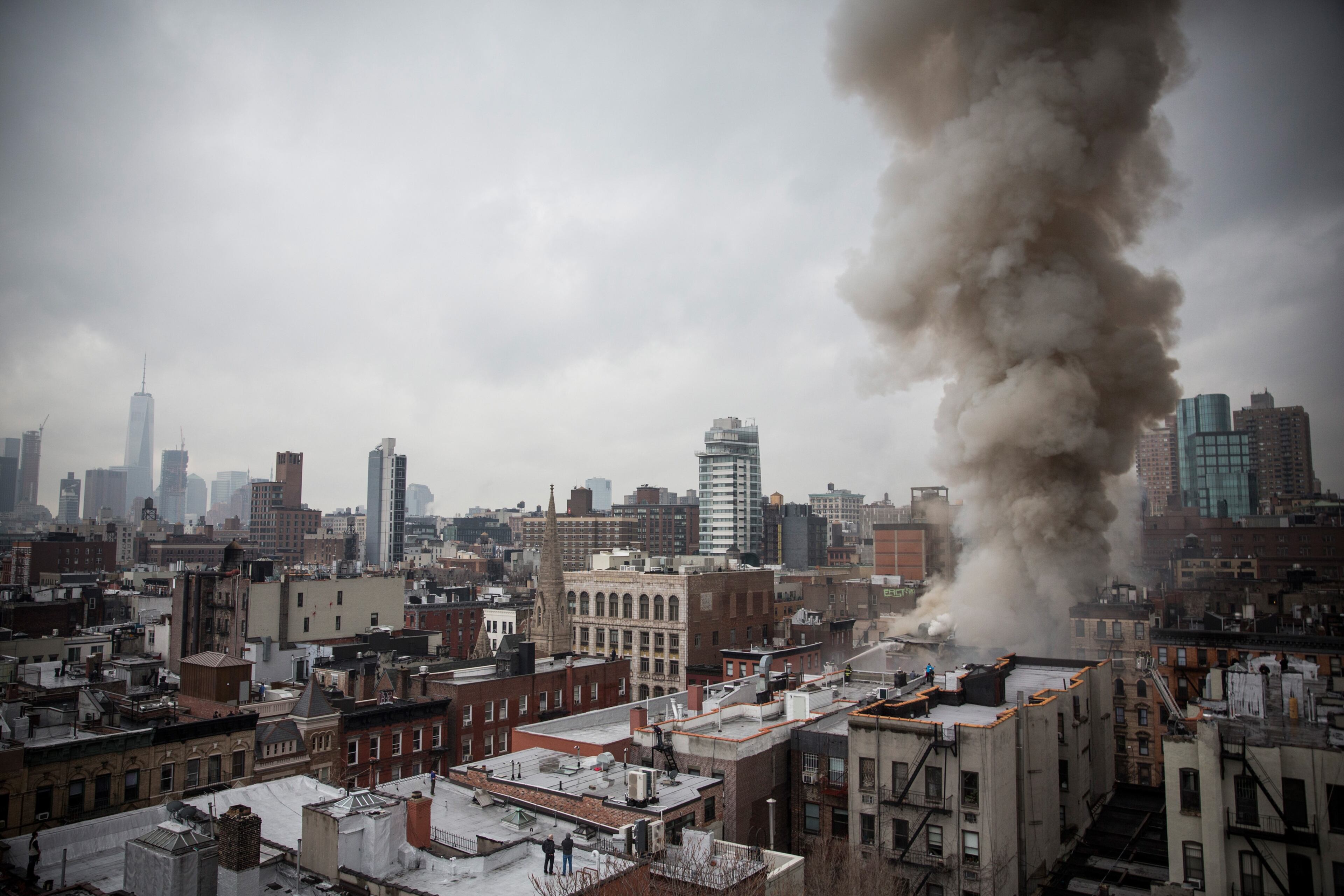NEW YORK, NY - MARCH 26: Smoke rises from a burning building after an explosion on 2nd Avenue on March 26, 2015 in New York City. The seven alarm fire drew firefighters from across the city. A number of injuries have been reported. (Photo by Andrew Burton/Getty Images)