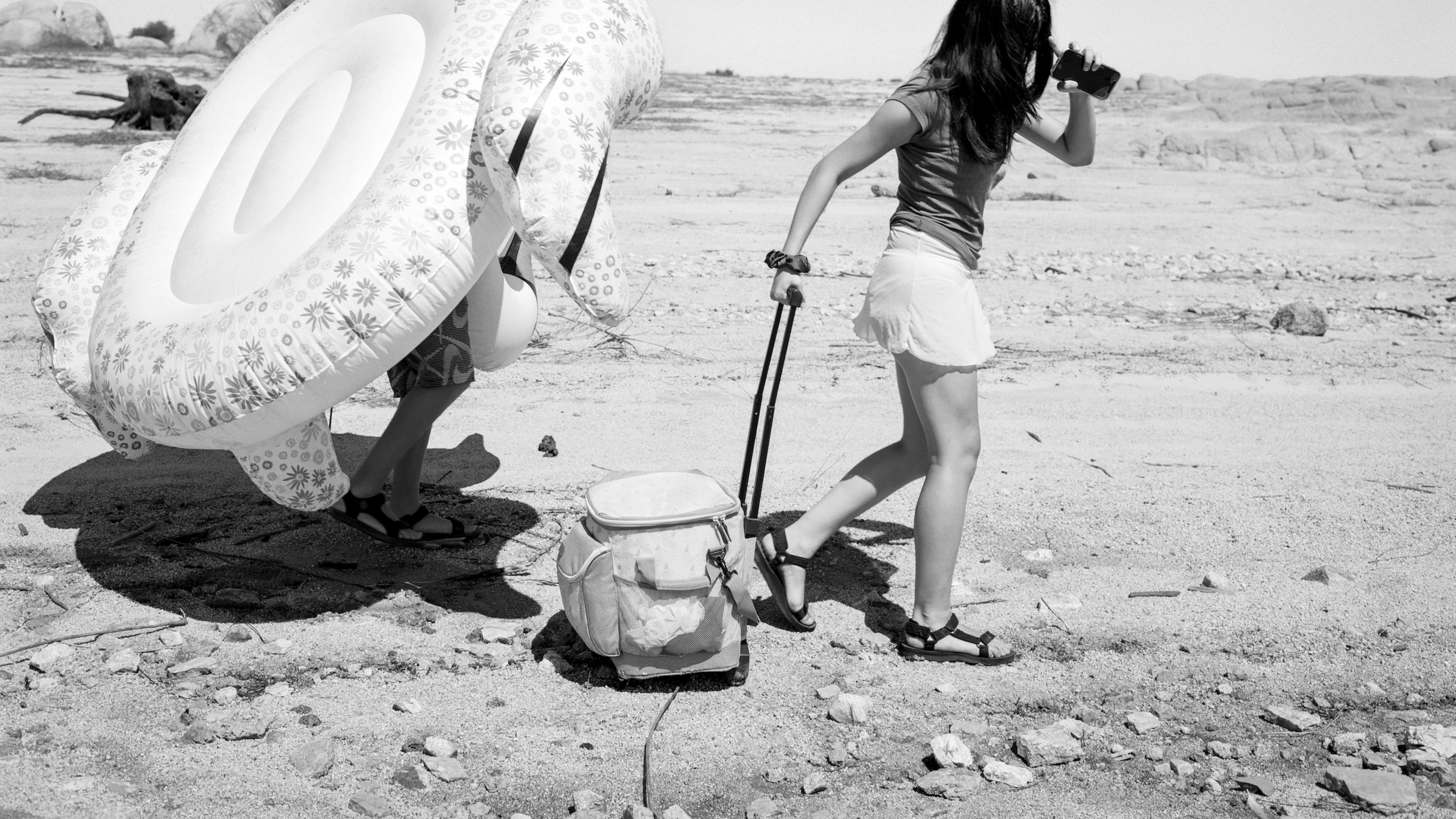 "Traveling to the Receding Lake II" (2021-2025) by Mimi Plumb from her series "The Reservoir." “People are kind of wandering aimlessly through this completely devastated landscape,” High Museum of Art photography curator Gregory J. Harris says of the series Plumb photographed at a parched reservoir outside Sacramento, California. (Photo courtesy of High Museum of Art/© Mimi Plumb)