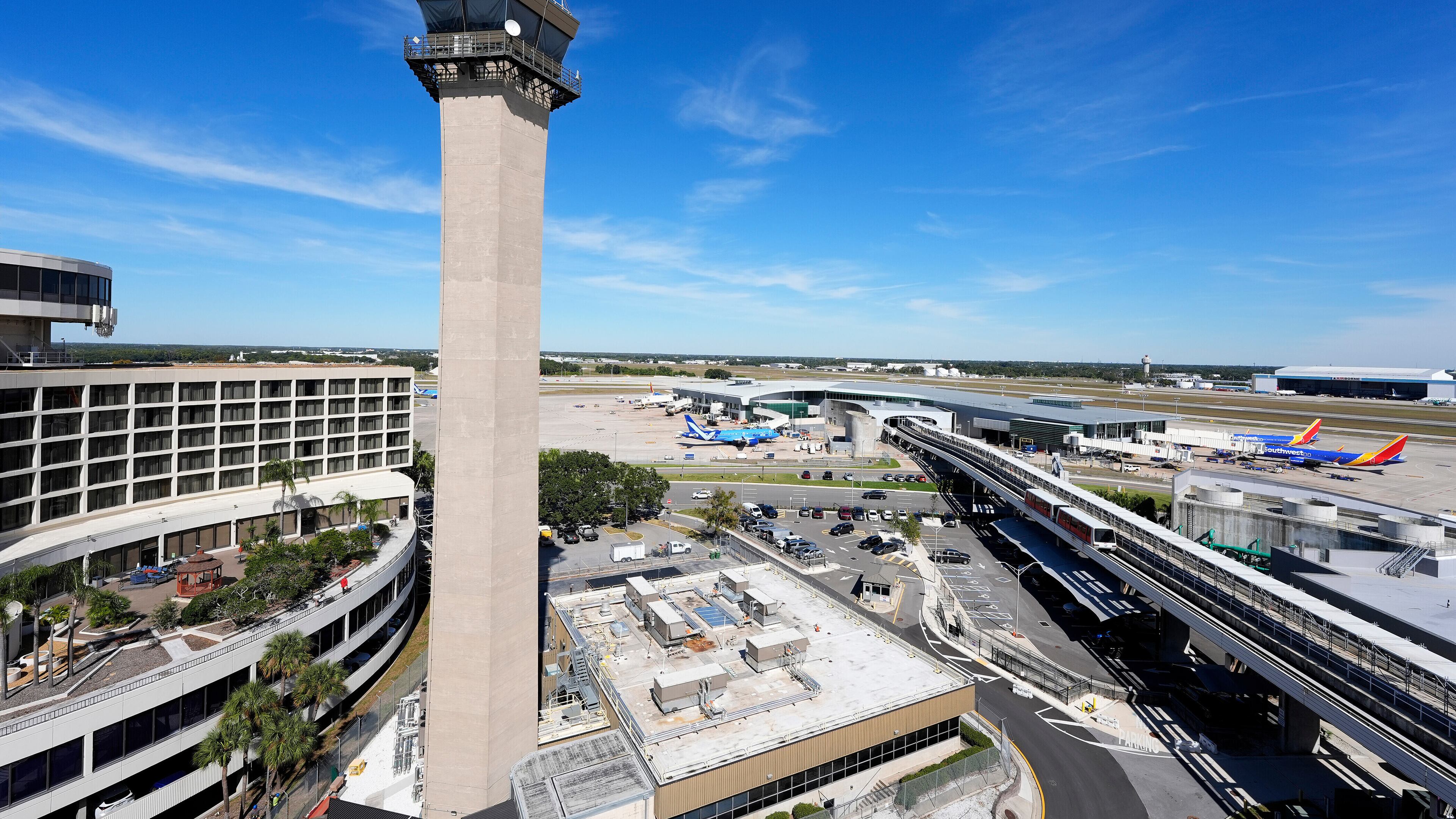 FILE - Airplanes are parked at gates near the air traffic control tower at the Tampa International Airport, Nov. 11, 2025, in Tampa, Fla. (AP Photo/Chris O'Meara, File)