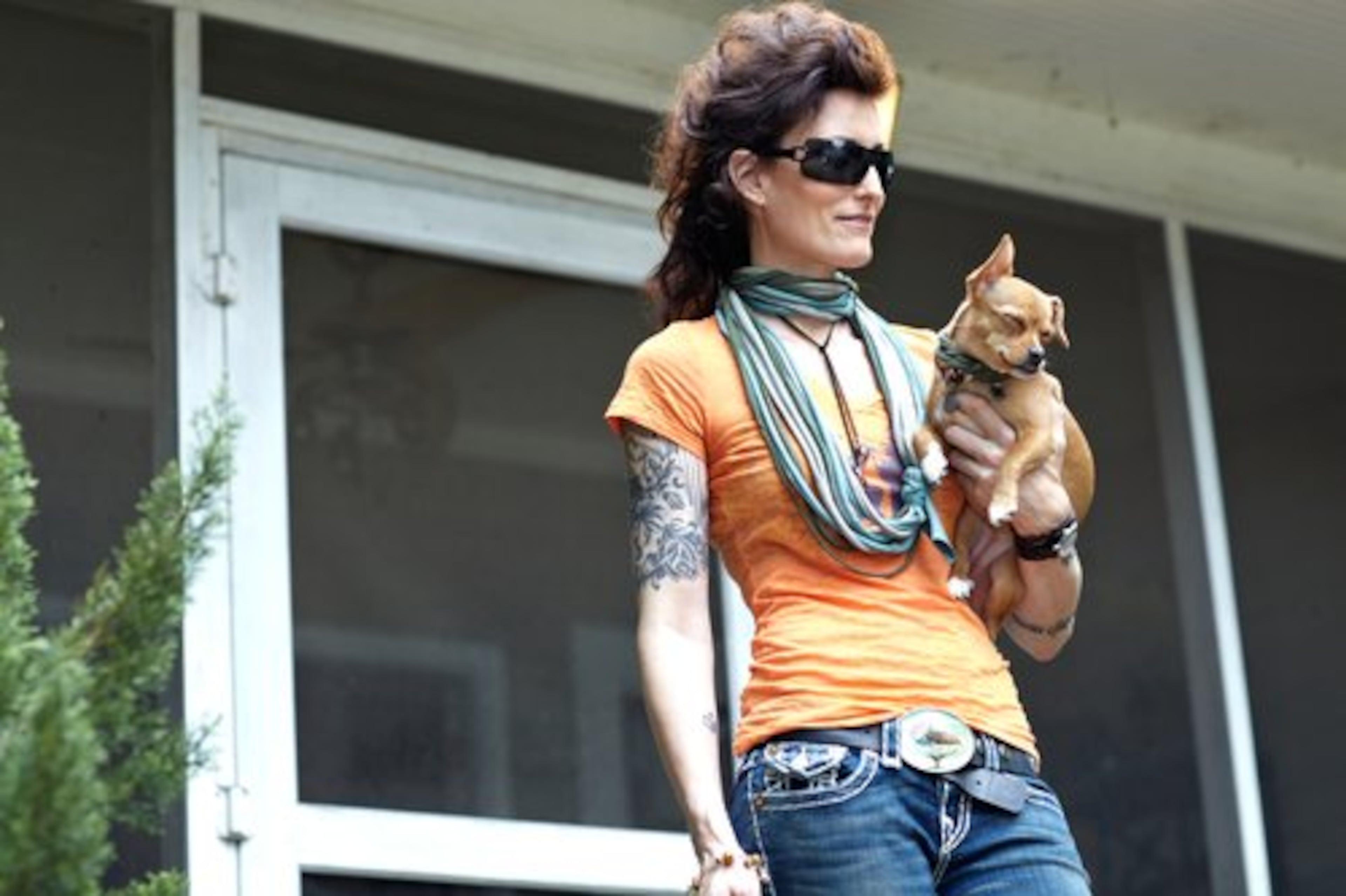 Laura Saunders, 46, of Inman Park owns Inman Park Pet Works and Fowlanguage. With her is Anabelle, a.k.a. Belly, a 10-month-old puppy and mama's girl. Saunders wears a burnout T-shirt from Dog Star, a pair of True Religion jeans and Burberry sunglasses. She and Belly also have matching scarves made from recycled T-shirts from Rust.