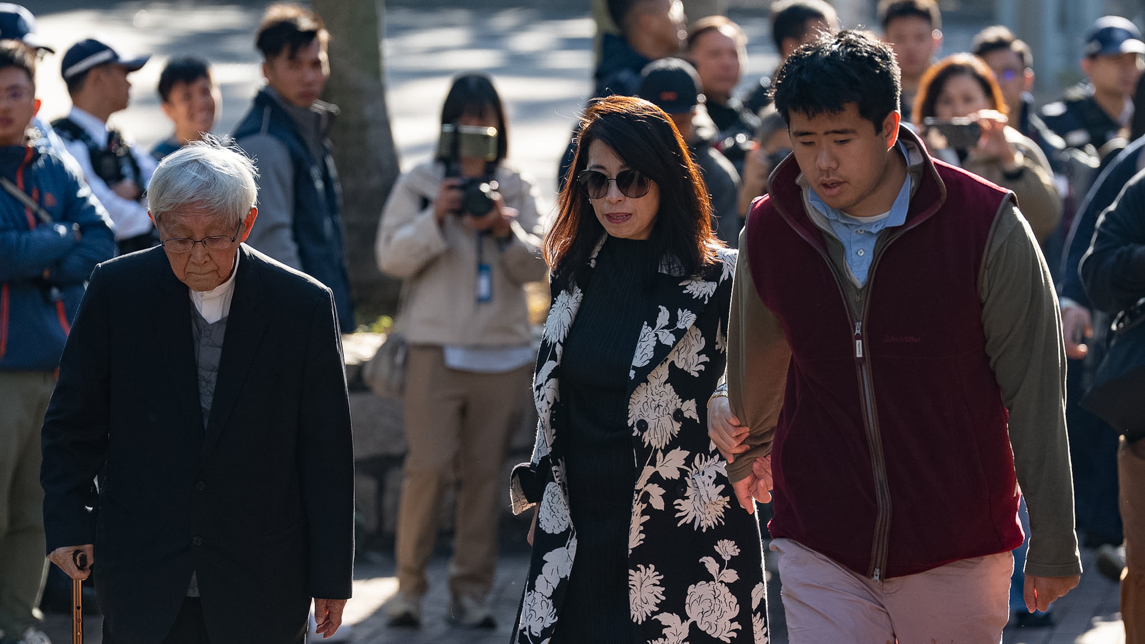 Retired Chinese cardinal Joseph Zen Ze-Kiun, from left, Jimmy Lai's wife Teresa Lai and Jimmy Lai's son Augustin Lai arrive at the West Kowloon Magistrates' Courts ahead of the verdict for Hong Kong activist publisher Jimmy Lai's national security trial in Hong Kong, Monday, Dec. 15, 2025. (AP Photo/Chan Long Hei)