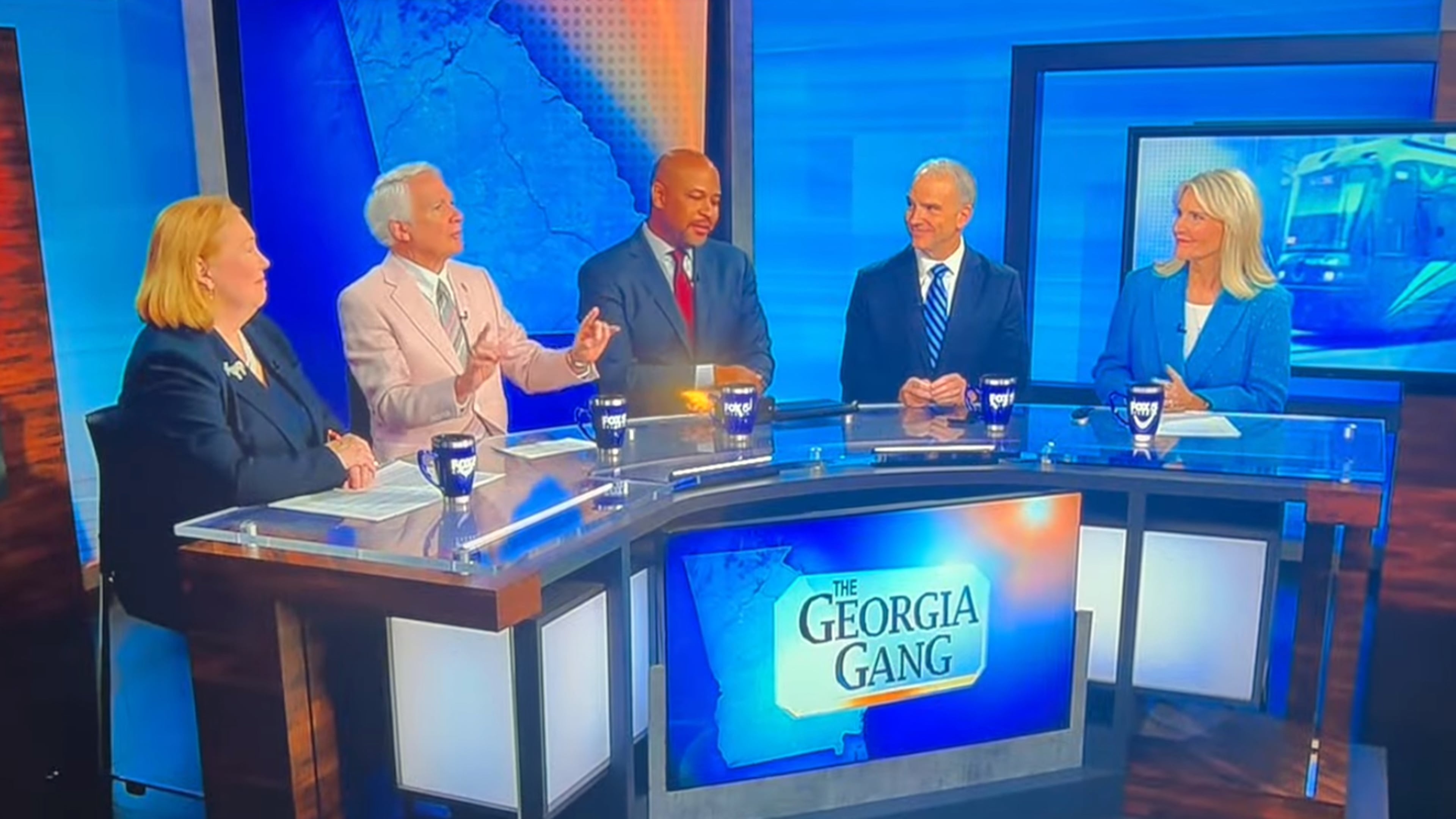 A screenshot from "The Georgia Gang" that aired on Fox 5 Aug. 23, 2026 after panelist Phil Kent (second from left) said free speech had limits, that a person shouldn't wear a T-shirt condoning violence like "Kill Tharon Johnson." Johnson, the panelist in the middle, reacted to that comment with a grimace and said, "Don't say that Phil." (FOX 5)