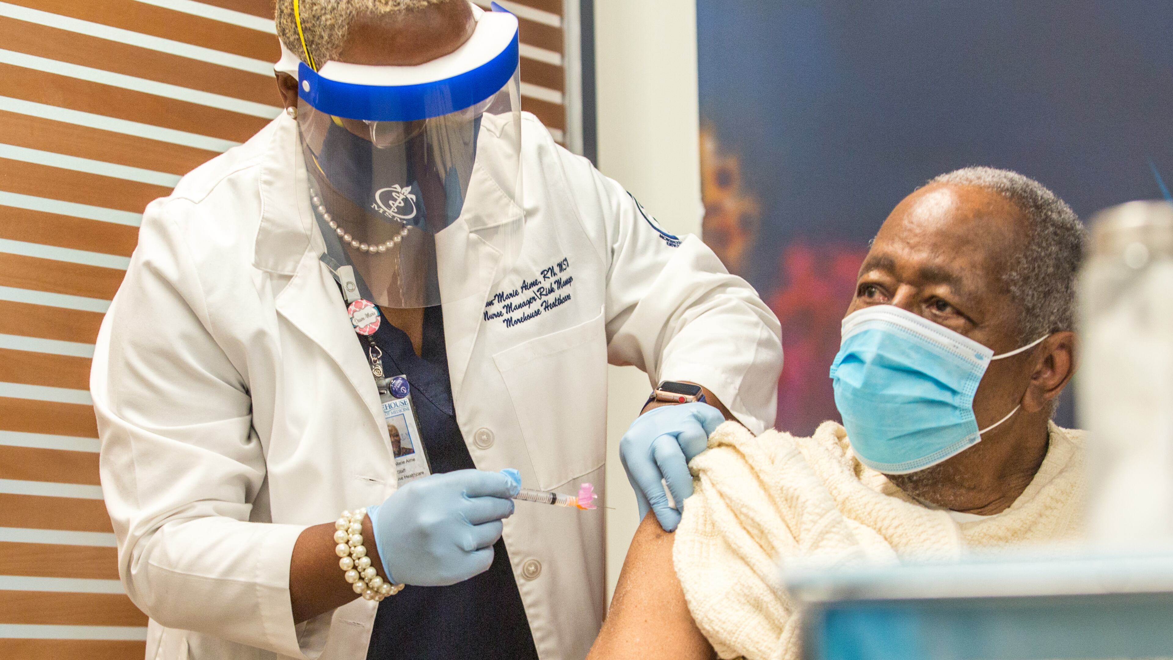 Morehouse School of Medicine nurse Dawn-Marie Aime, left, administers the first of two Moderna Covid-19 vaccines to Hank Aaron on Tuesday, Jan. 5. Vaccinations will be available begining Monday, Jan. 11, for all residents 65 and older of the North Georgia Health District, six counties north of Atlanta including Cherokee County. (Jenni Girtman for The Atlanta Journal-Constitution)