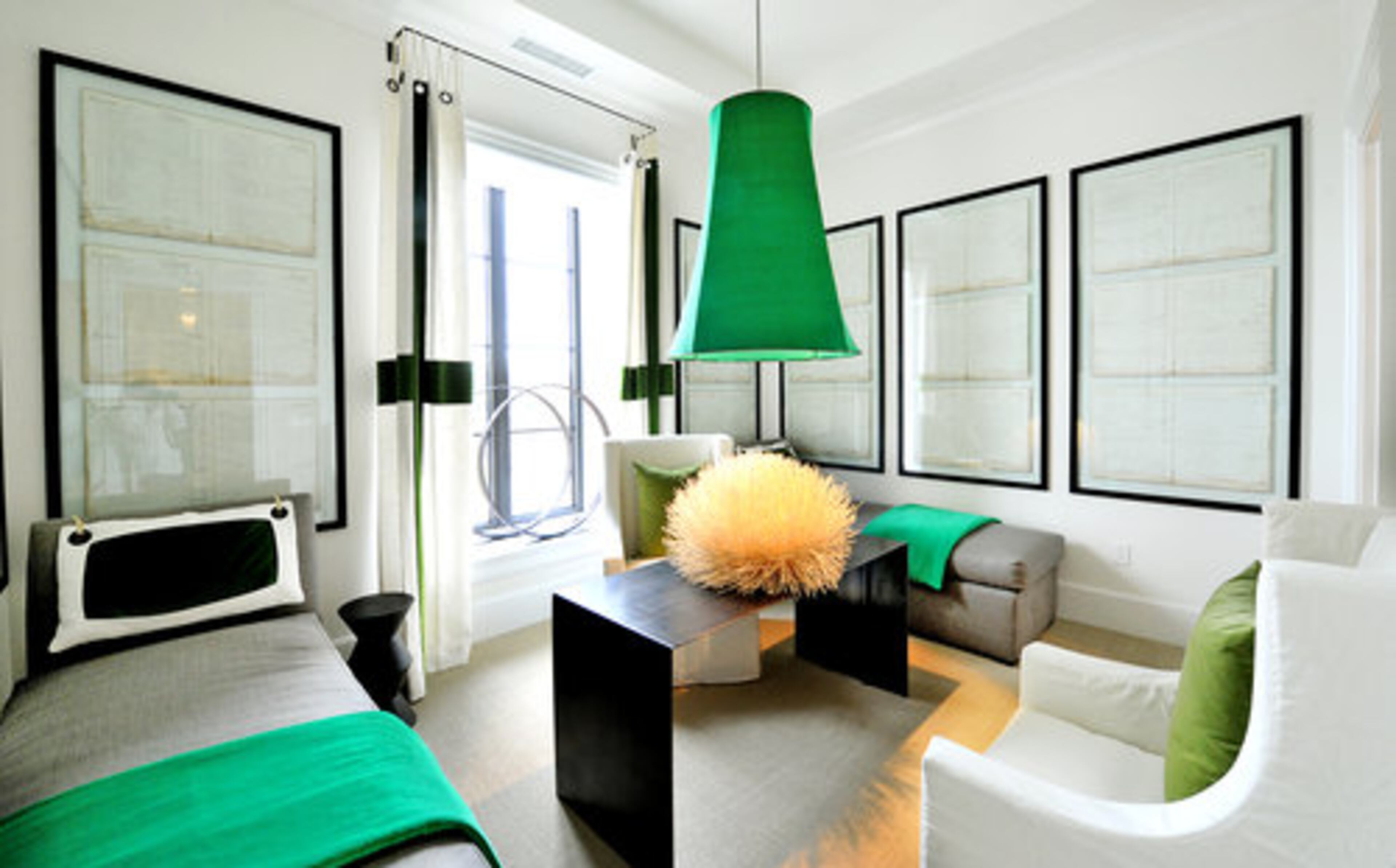 The gentleman's guest room, designed by Kay Douglass and Dixie Peeples, is among the more surprising spaces with flanking charcoal daybeds and funky accents of kelly green in the drapery, bedding and oversized lantern hanging above coral.