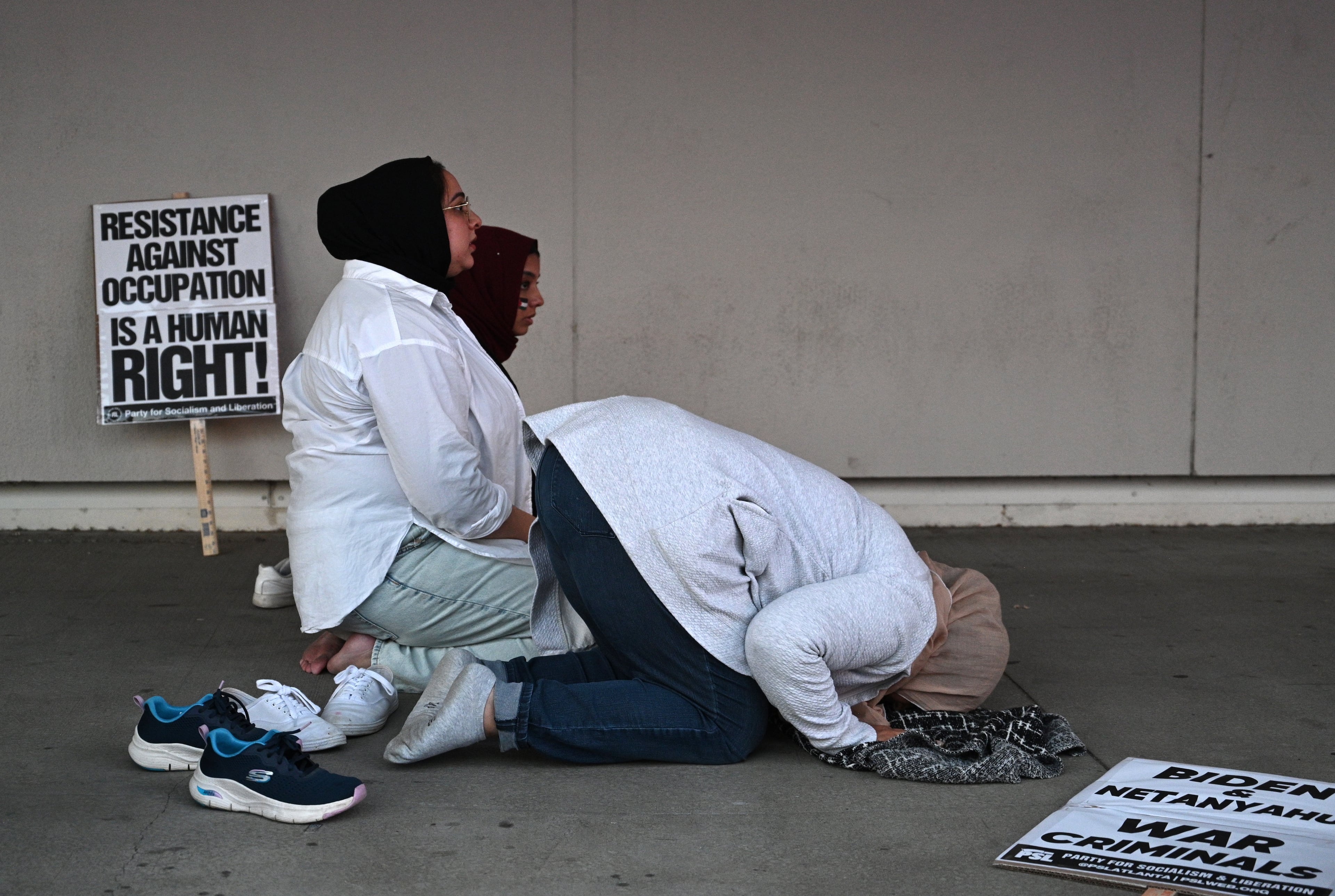 Pro-Palestinian supporters pray during a rally in front of the CNN Center, Friday, October 20, 2023, in Atlanta. Hundreds of people gathered in downtown Atlanta. (Hyosub Shin / Hyosub.Shin@ajc.com)