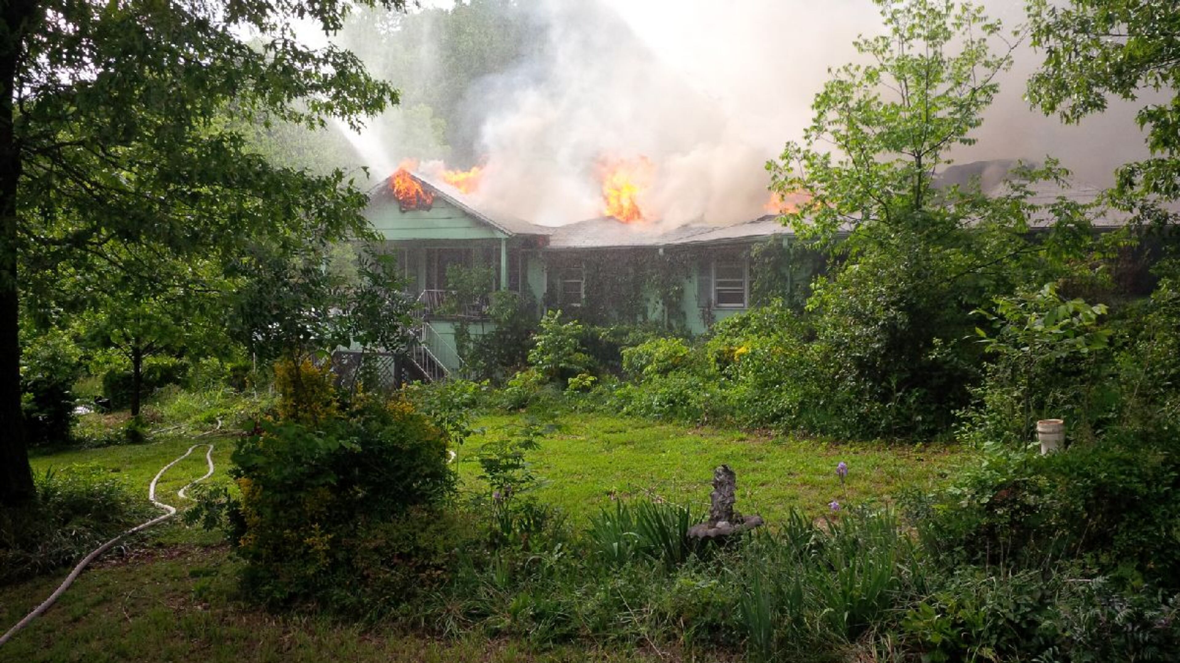 Firefighters responded to the single-story home on the 2600 block of Lawrenceville's Five Forks Trickum Road around 4:10 p.m., finding flames erupting from the attic. (Credit: Gwinnett County fire department)