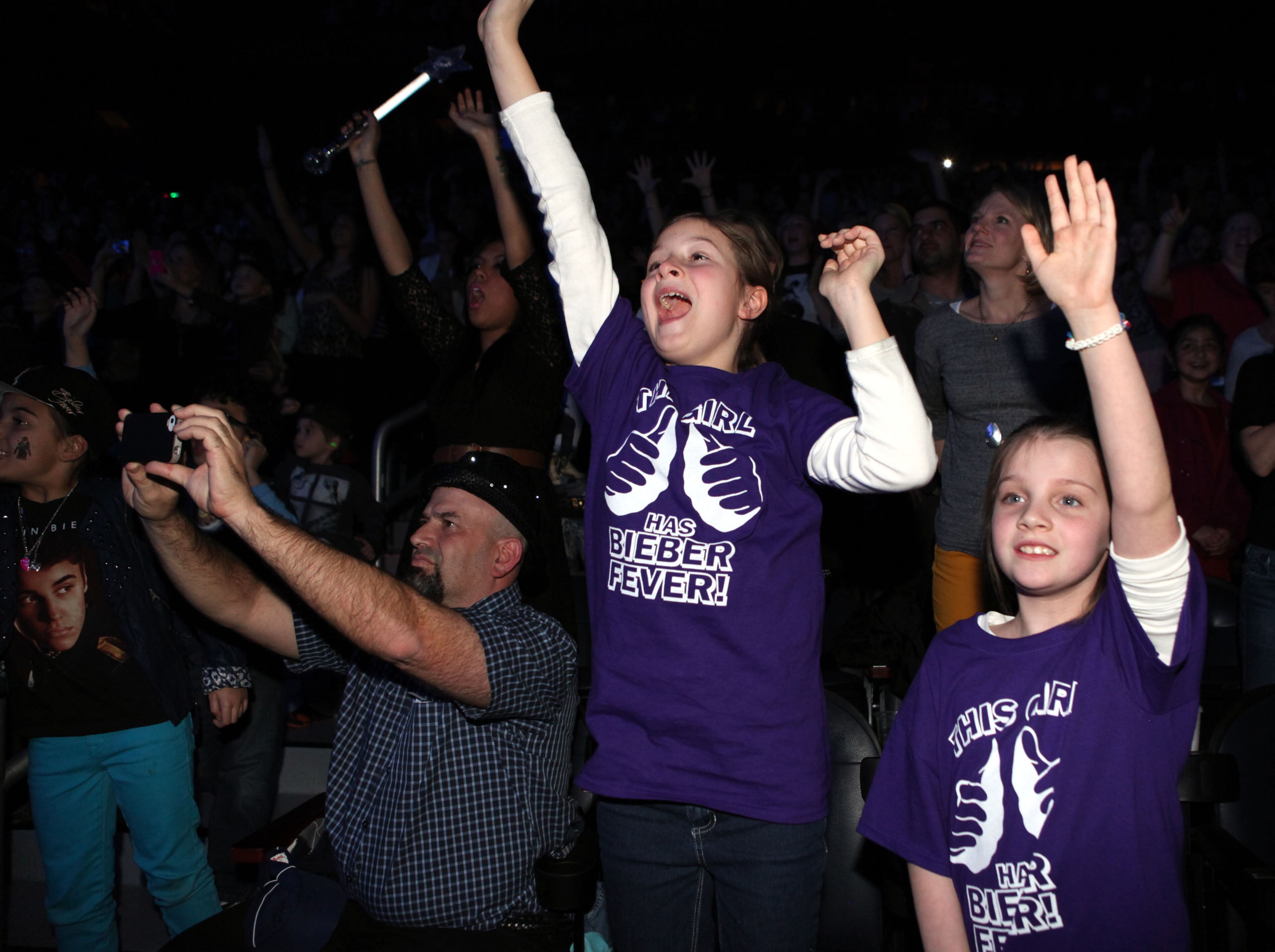 Caroline Stakez (left) and Virginia Hartsele show their excitement as Justin Bieber hits the stage.