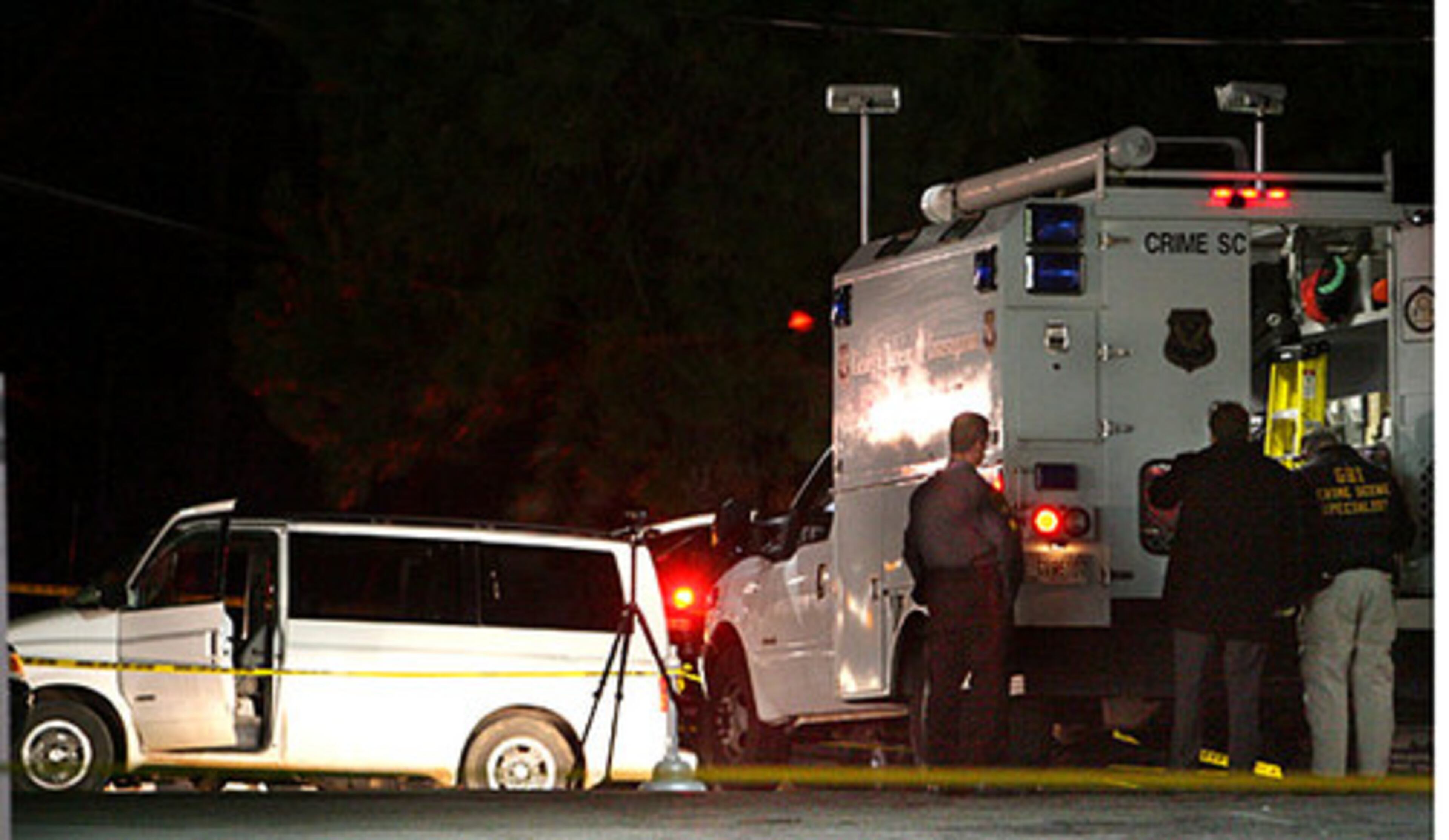 A white van sits near an outdoor vacuum cleaner unit at a Chevron station at the corner of Johnson Ferry Road and Peachtree Dunwoody Road in DeKalb County on January 4 about 11 pm, shortly after a GBI Crime Scene Unit (at right foreground) arrived to go over the van. The Chevron station is adjacent to the Cambridge Square shopping center. Gary Michael Hilton was discovered at this station with the van.