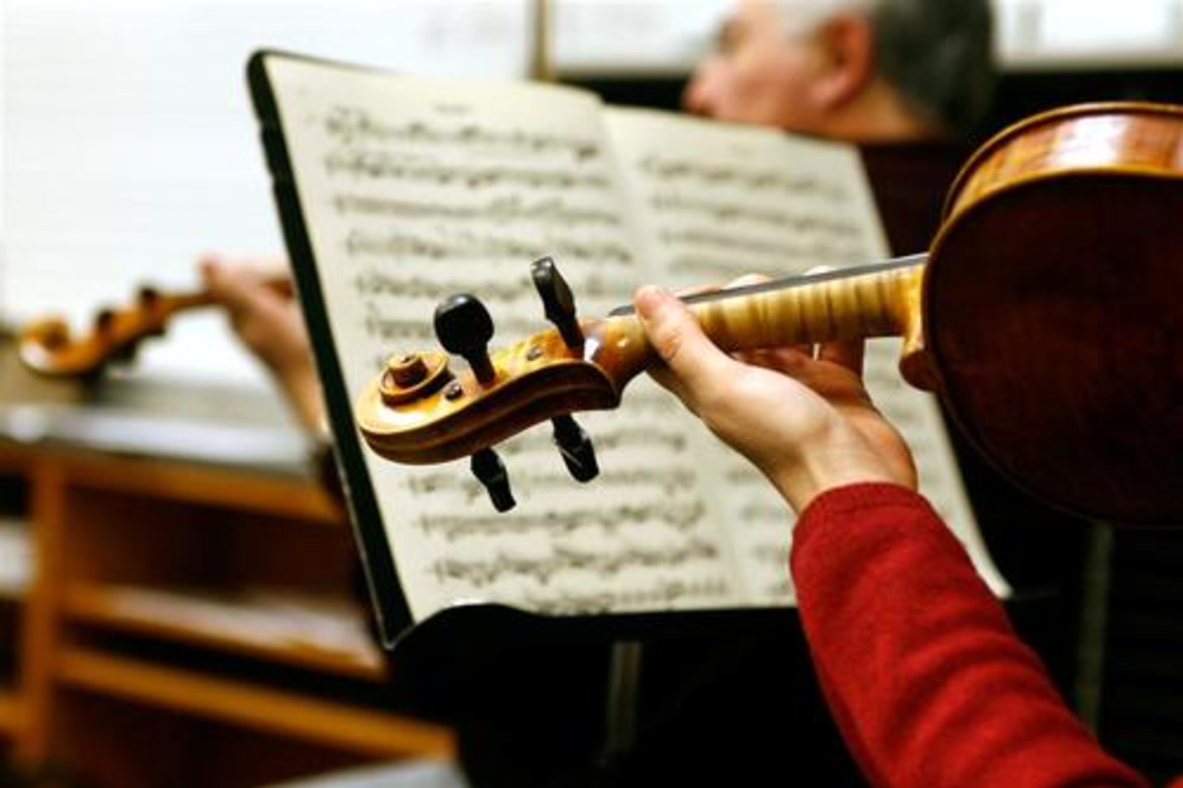 A violinist performs as Johns Creek Symphony Orchestra practices.