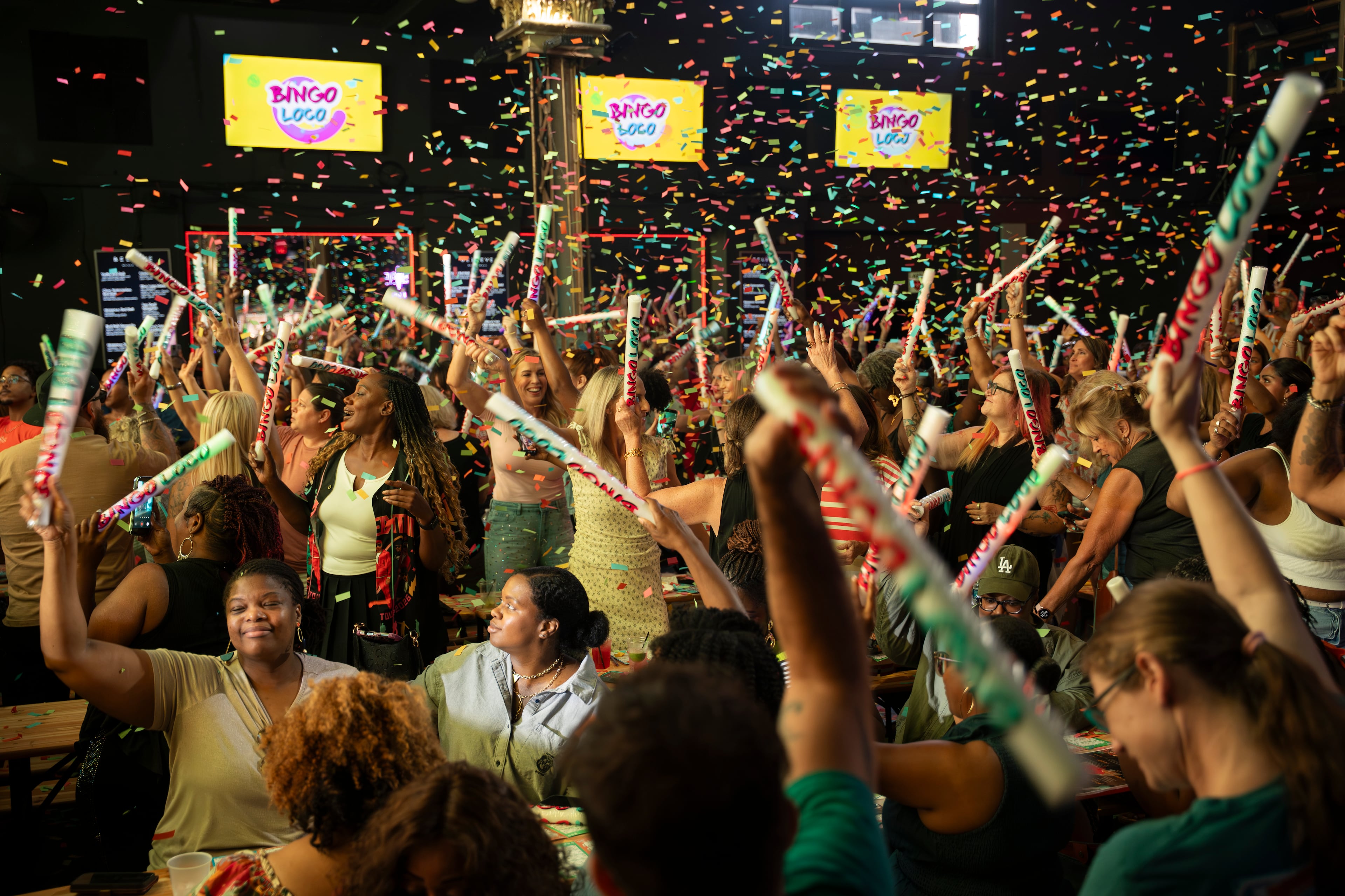 Partygoers throw their hands in the air, scream and dance as a DJ spins a throwback anthem during Bingo Loco, a touring bingo rave party, at Believe Music Hall in Atlanta on Saturday, July 18, 2026. The Ireland-born show turns traditional bingo into an immersive, festival-style stage production, complete with comedian emcees, dance-offs, lip-sync battles and confetti cannons, and has sold out shows in more than 200 cities worldwide. (Olivia Bowdoin for the AJC)