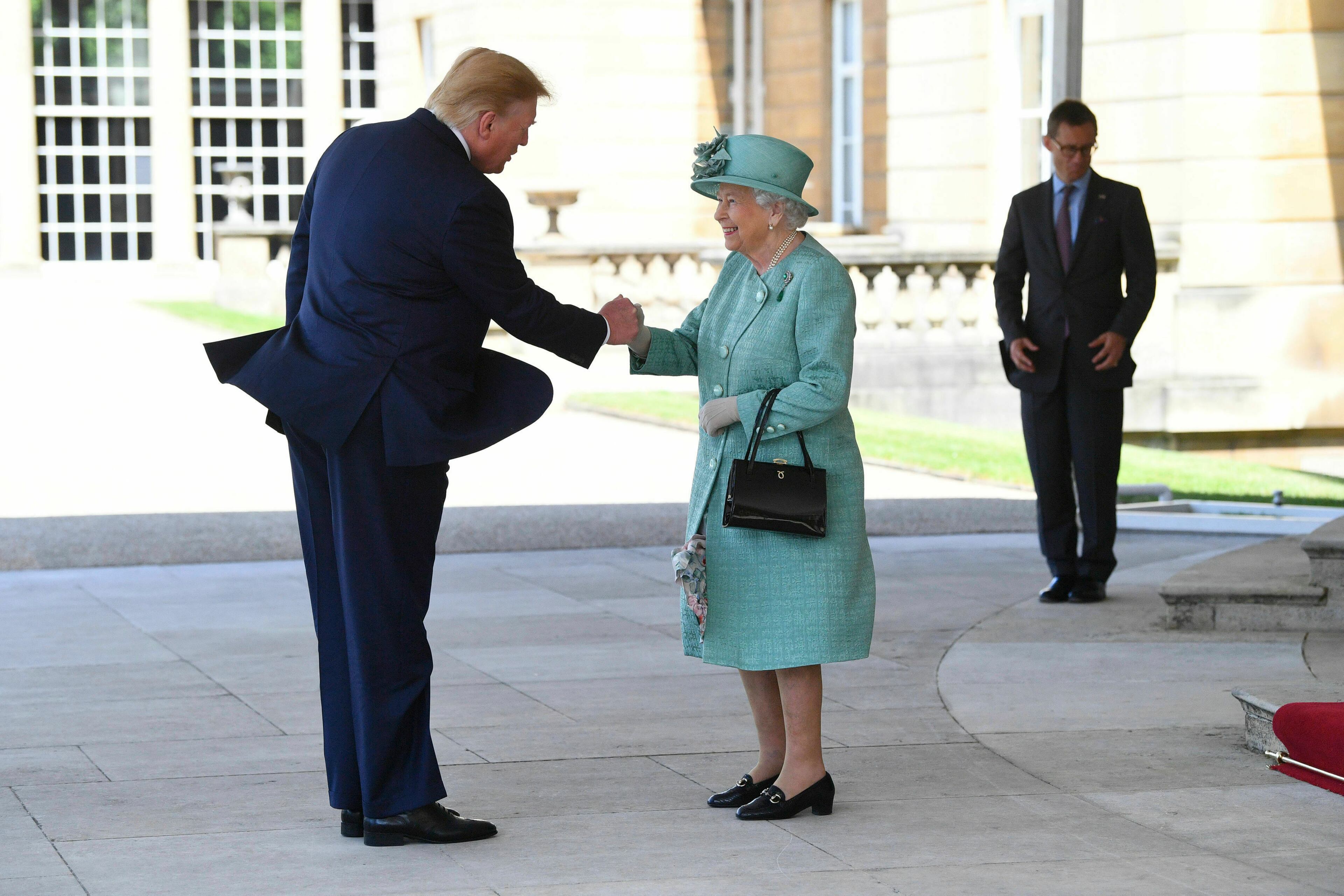 Britain's Queen Elizabeth II greets President Donald Trump as he arrives for a welcome ceremony in the garden of Buckingham Palace, in London, Monday, June 3, 2019, on the first day of a three day state visit to Britain. (Victoria Jones/Pool via AP)