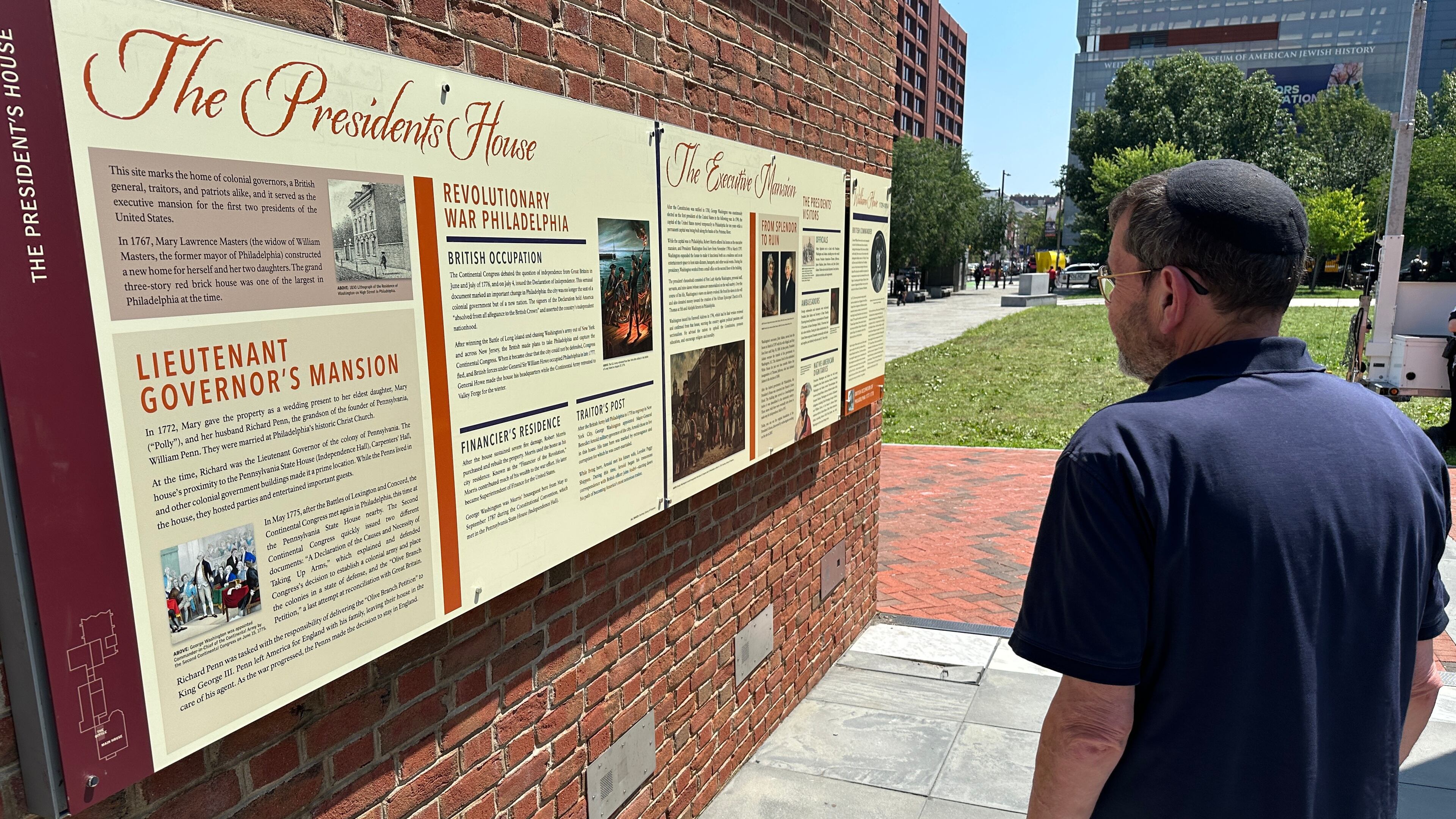 Visitors view the reinstalled educational panels about slavery at the site of President George Washington's home in Philadelphia, Wednesday, July 15, 2026. (AP Photo/Tassanee Vejpongsa)