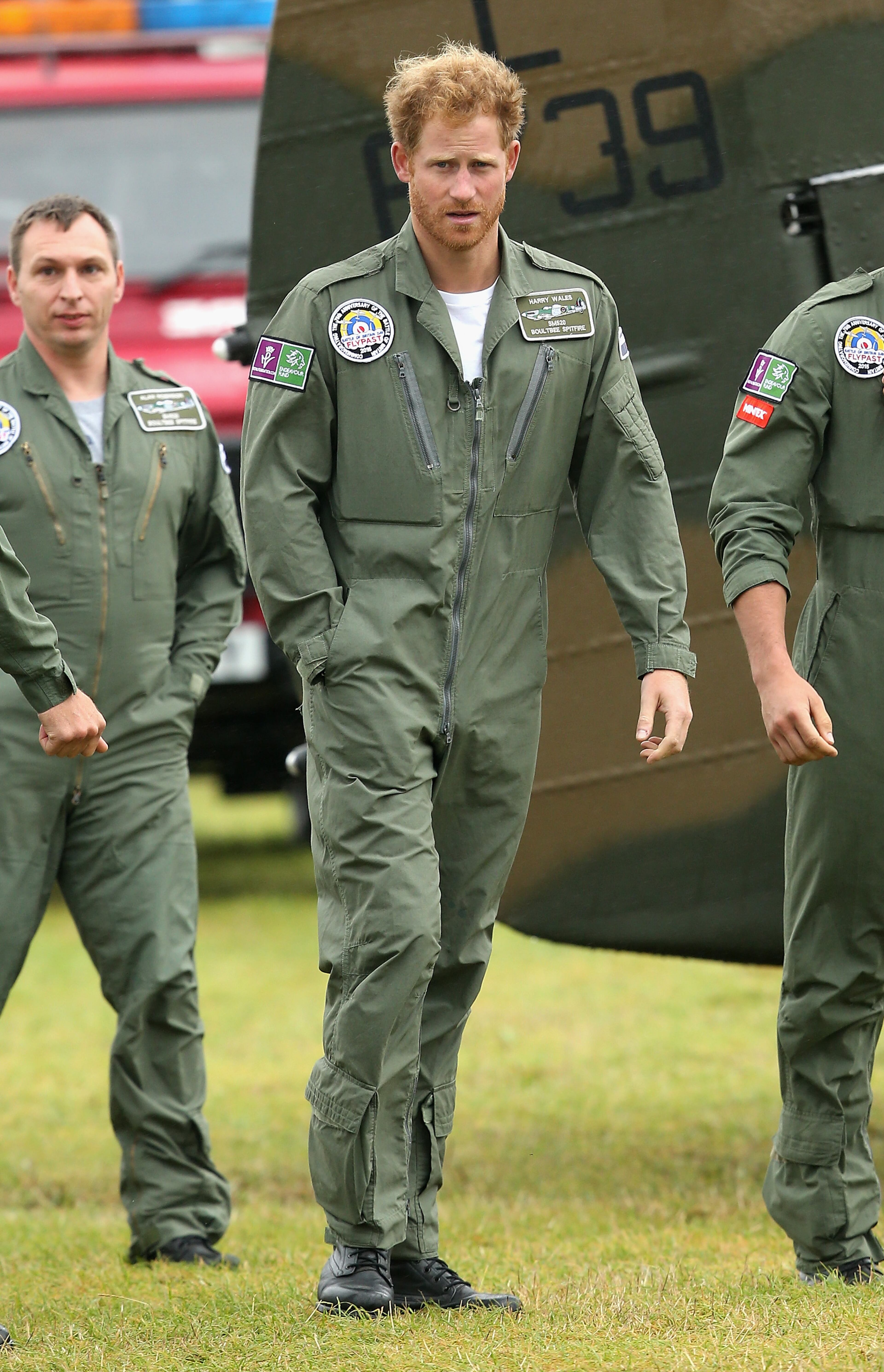 CHICHESTER, ENGLAND - SEPTEMBER 15: Prince Harry walks on the airfield at Goodwood Aerodrome as he is shown Spitfire Aircraft that will take place in a Battle of Britain Flypast at Goodwood on September 15, 2015 in Chichester, England. The 75th Anniversary of the Battle of Britain is being marked by a historic flypast that brings more Battle of Britain aircraft together than ever before as a show of thanks to 'the few' and the sacrifices they made. (Photo by Chris Jackson/Getty Images)