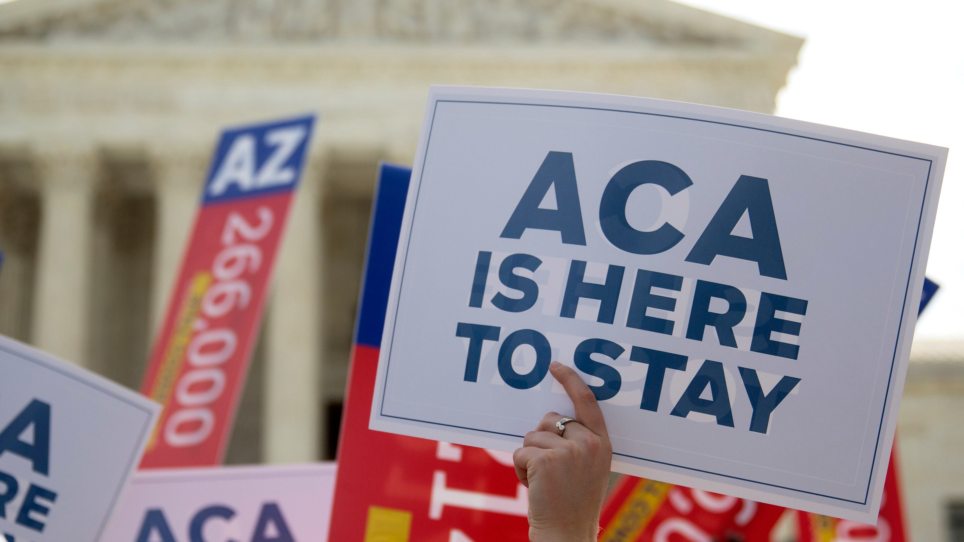 A demonstrator in support of U.S. President Barack Obama's health-care law, the Affordable Care Act (ACA), holds up a sign after the U.S. Supreme Court ruled 6-3 to save Obamacare tax subsidies outside the Supreme Court in Washington. Bloomberg/Andrew Harrer