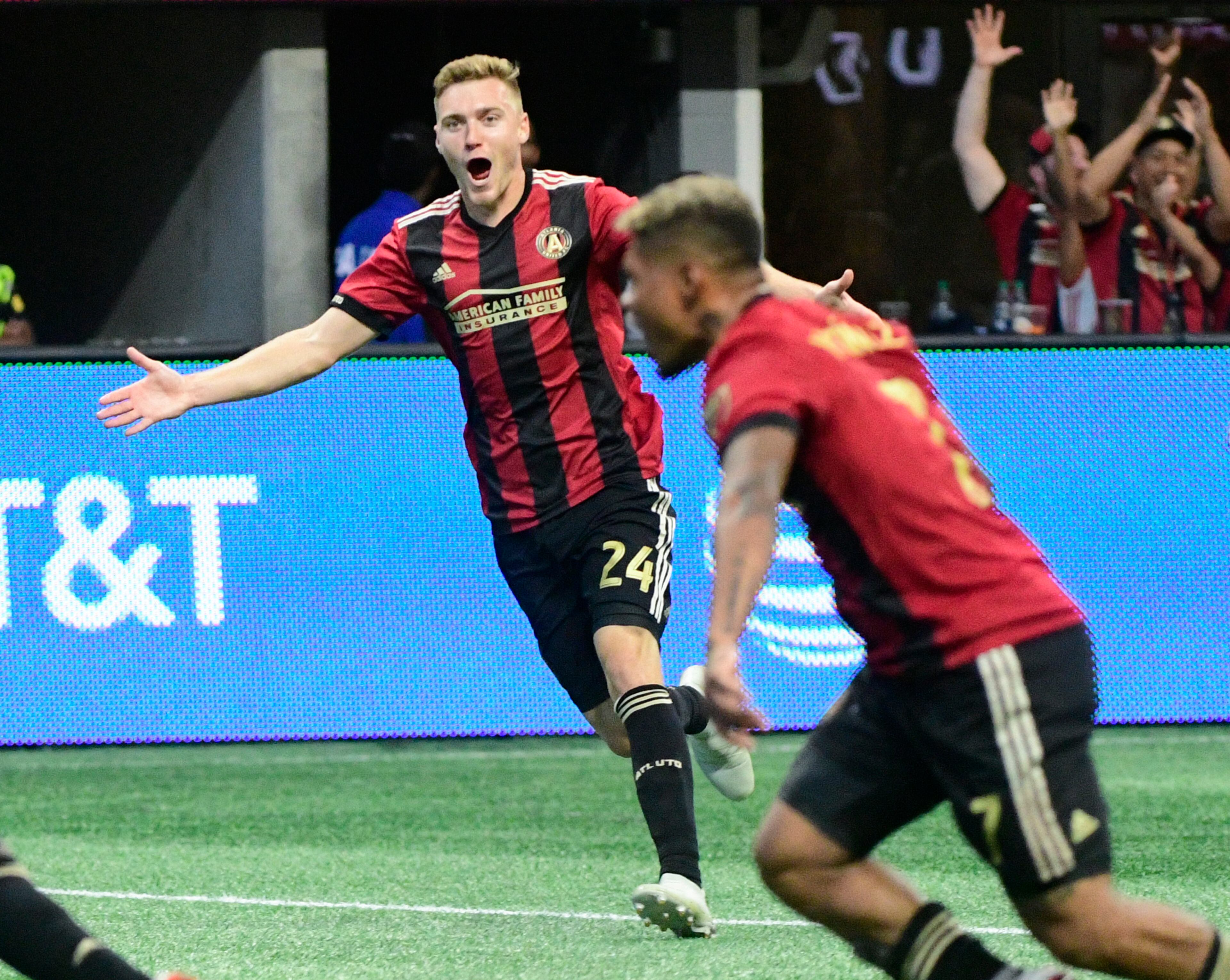Atlanta United's Julian Gressel celebrates a goal by George Bello, along with forward Josef Martinez, right, during the first half of an MLS soccer game against the New England Revolution, Saturday, Oct. 6, 2018. Gressel scored the next goal of the game in the second half.(John Amis)