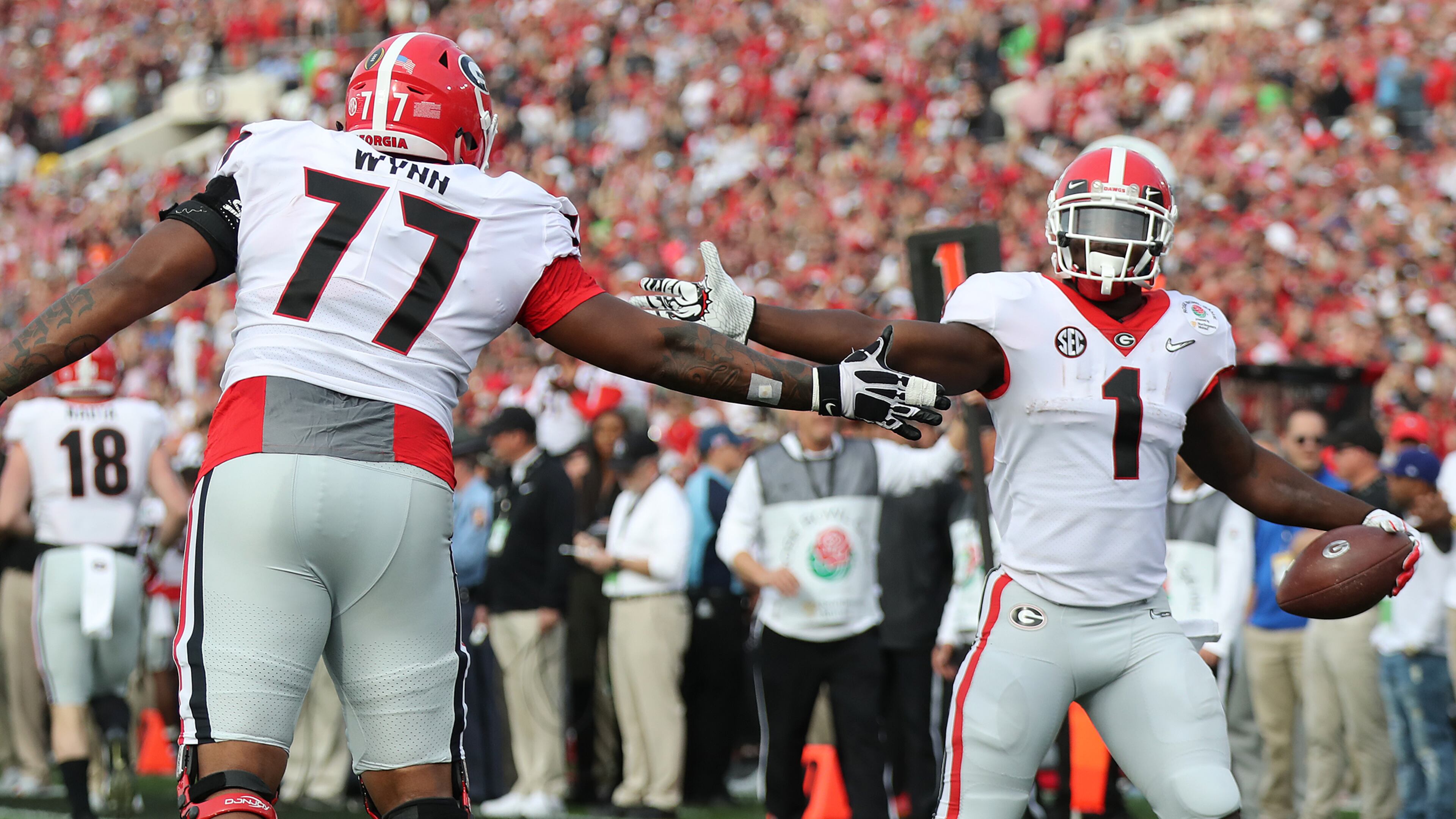 January 1, 2018 Pasadena: Sony Michel gets five from Isaiah Wynn after scoring a touchdown against Oklahoma during the first quarter in the College Football Playoff Semifinal at the Rose Bowl Game on Monday, January 1, 2018, in Pasadena. Curtis Compton/ccompton@ajc.com