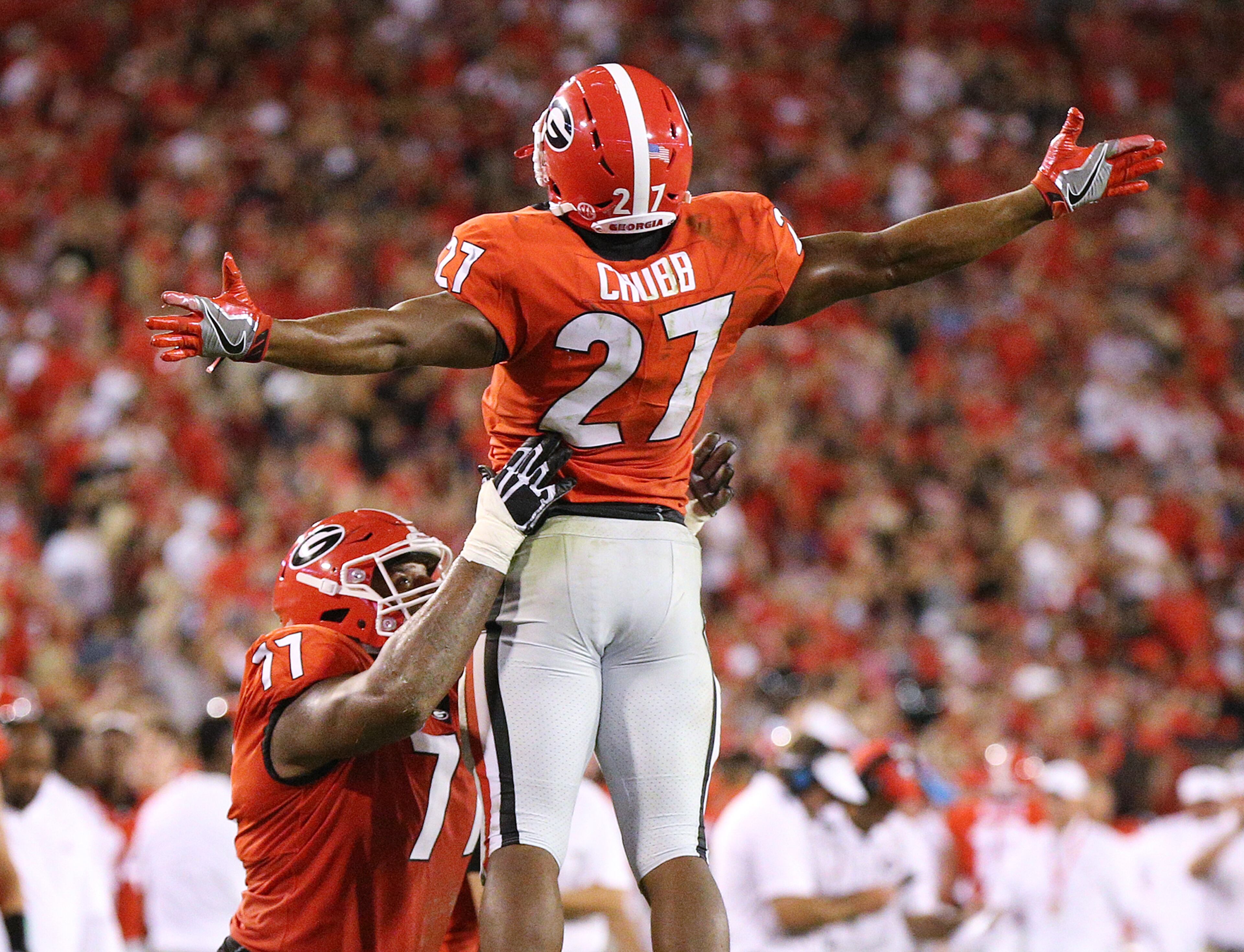 September 2, 2017 Athens: Georgia running back Nick Chubb is hoisted in the air by offensive lineman Isaiah Wynn scoring a touchdown for a 31-0 lead against Appalachian State during the third quarter in a NCAA college football game on Saturday, September 2, 2017, in Athens. Curtis Compton/ccompton@ajc.com