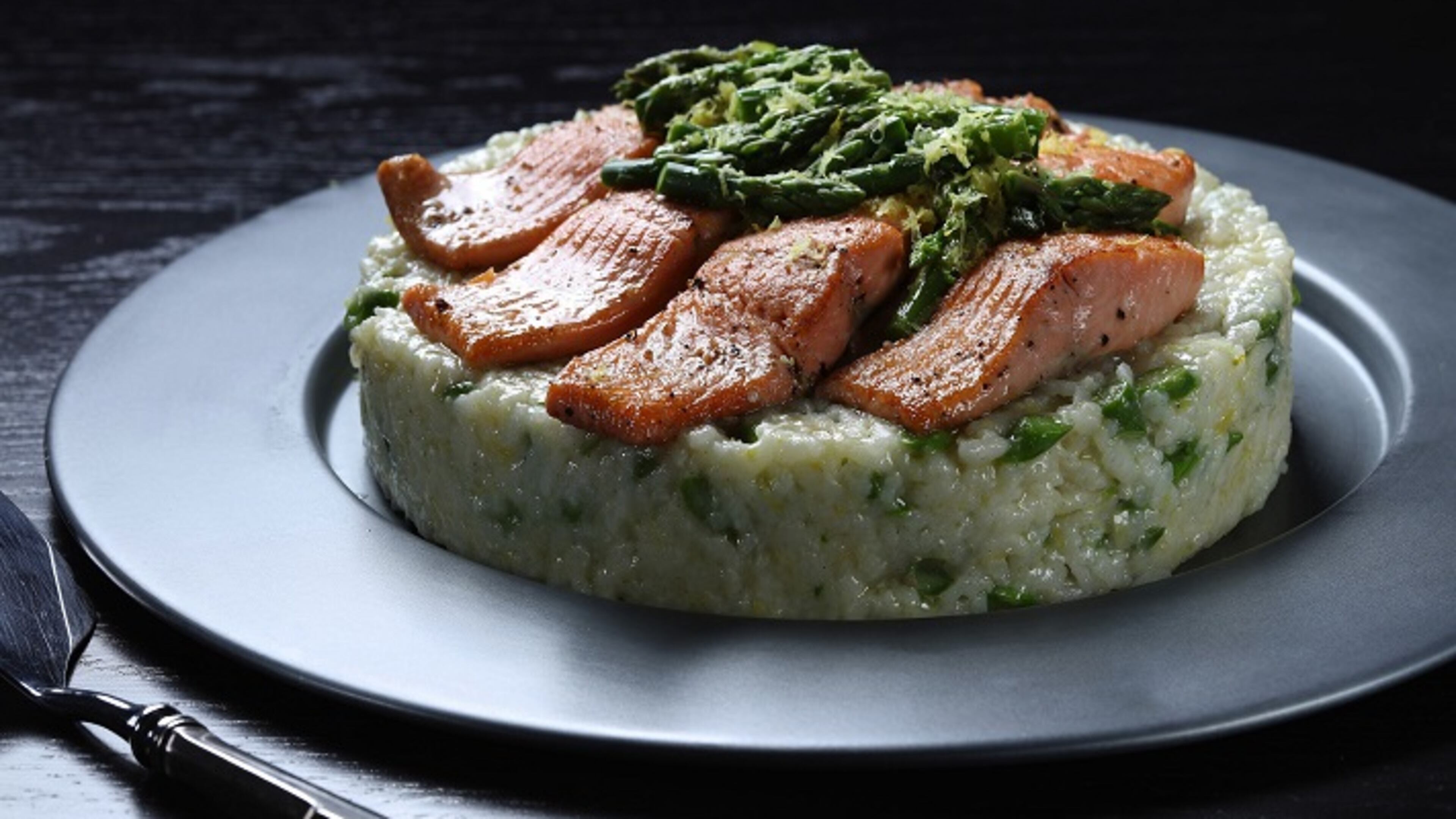 Italian rice salads, a staple of the country's cuisine but not well known here, get plenty of attention in chef John Coletta's book "Risotto & Beyond." This version features an asparagus-studded mold of rice, topped with trout and an asparagus relish. (Abel Uribe/Chicago Tribune/TNS)