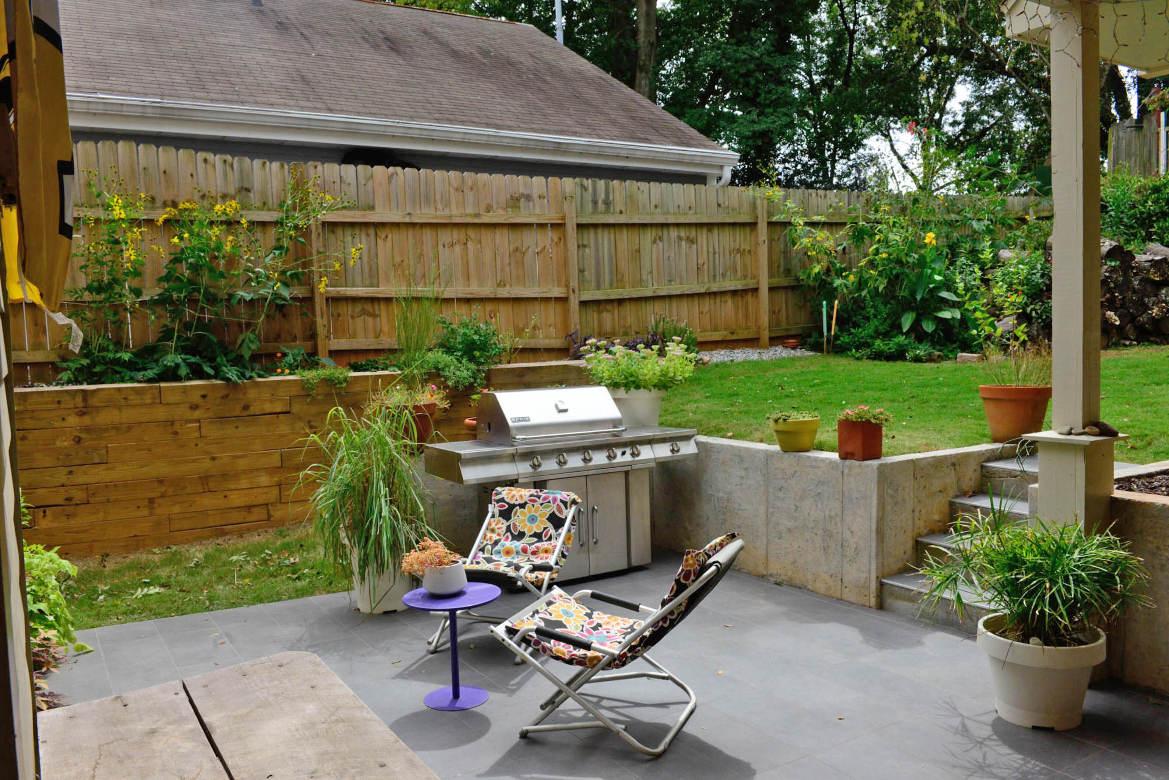 The partially covered back patio serves as an extension of the kitchen when weather is nice. Kirk added the retaining wall with built-in concrete steps, and the patio gives Karen ample space for container gardening.
