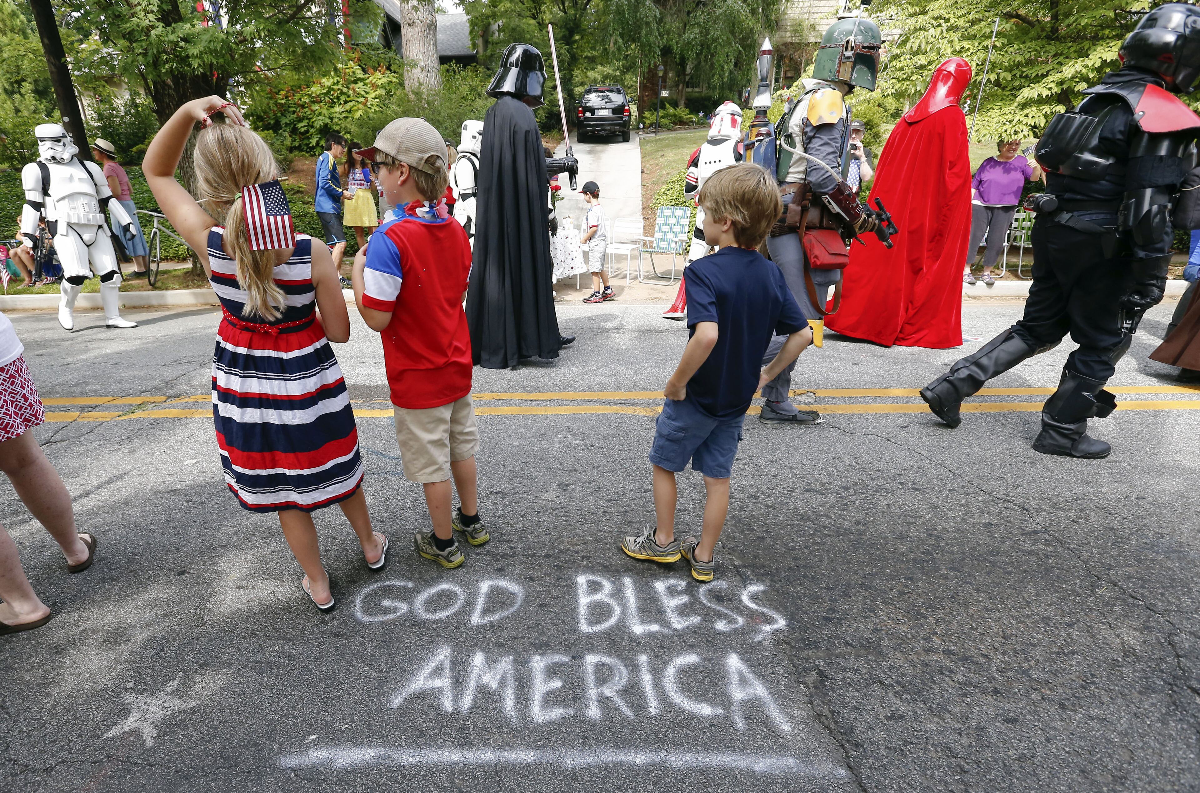 Children watch an Independence Day parade in Avondale Estates, Georgia, USA, 04 July 2014. The Fourth of July festivities mark the 238th year the United States broke away from Great Britain. Erik S. Lesser/European Pressphoto Agency