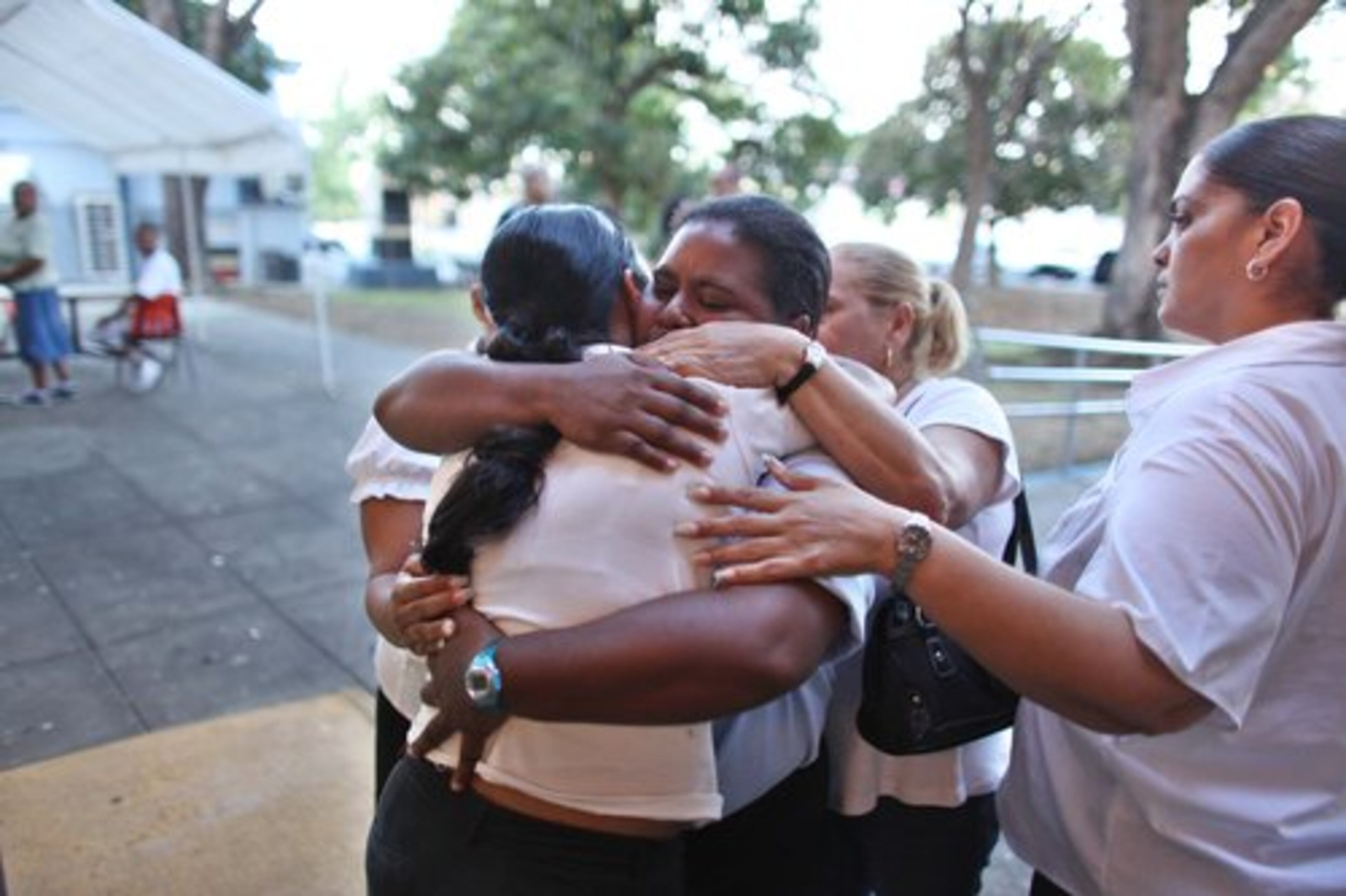 Relatives of Navedo react in front of a police station after he was arrested.