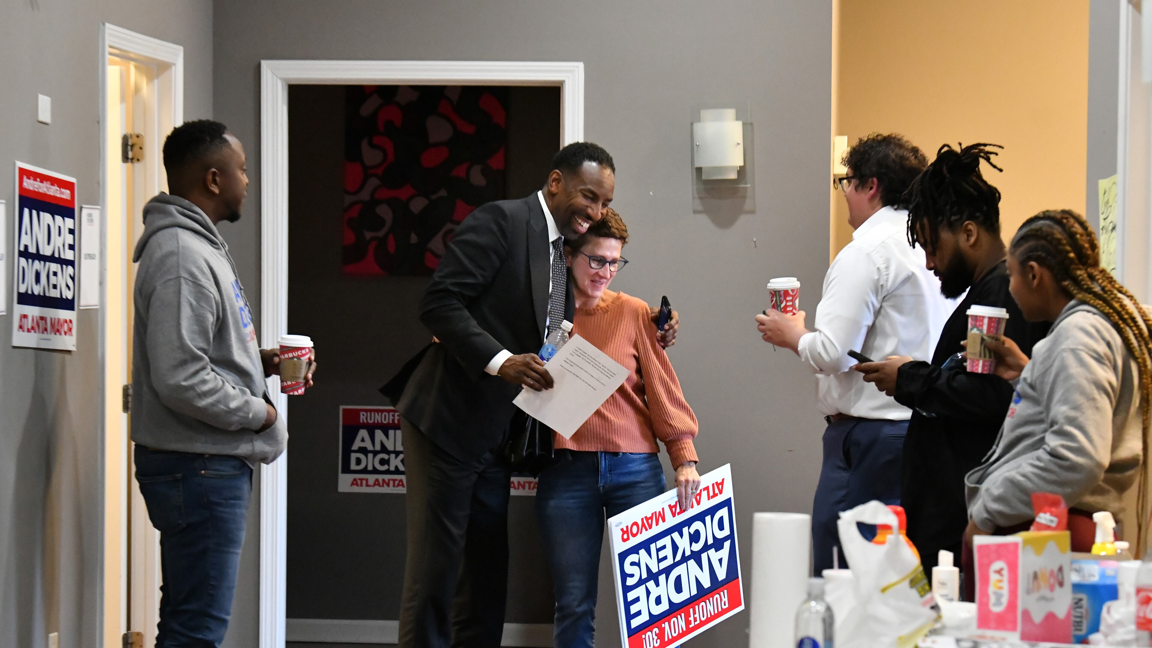 December 1, 2021 Atlanta - Mayor-elect Andre Dickens (second from left) greets Jenifer Keenan, Chairwoman of the Andre Dickens Mayoral Campaign Committee, with a hug at his campaign headquarters on Wednesday, December 1, 2021. Andre Dickens, the Atlanta native who first beat an incumbent eight years ago for a spot on the City Council, defeated Felicia Moore in TuesdayÕs runoff election to become AtlantaÕs 61st mayor. (Hyosub Shin / Hyosub.Shin@ajc.com)