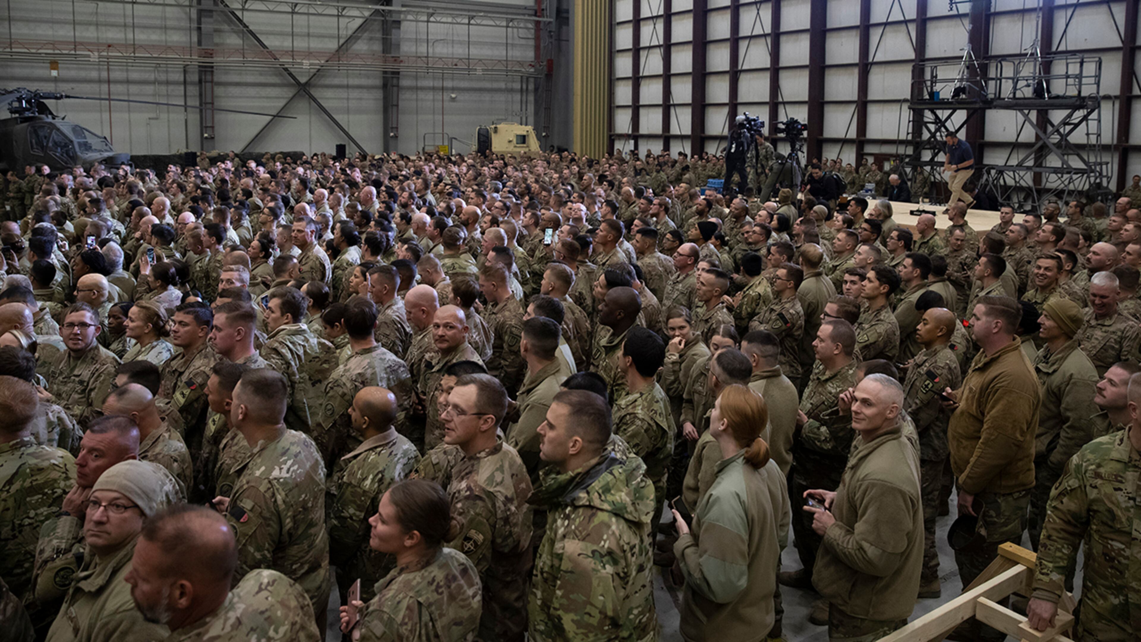 Members of the military await a surprise Thanksgiving Day visit from President Donald Trump, Thursday, Nov. 28, 2019, at Bagram Air Field, Afghanistan. (AP Photo/Alex Brandon)