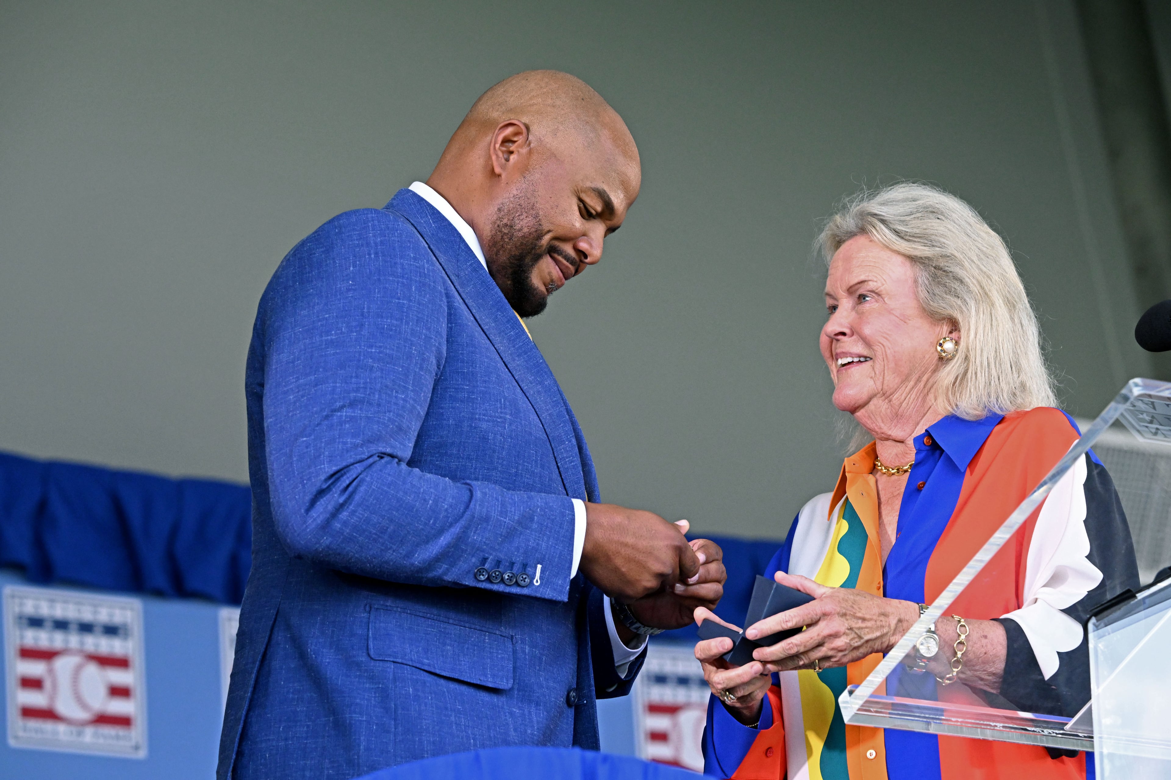 Andruw Jones receives a Hall of Fame ring from Jane Clark, chairman of the board of directors of the National Baseball Hall of Fame and Museum, during the 2026 National Baseball Hall of Fame Induction Ceremony at the Clark Sports Center on Sunday, July 26, 2026, in Cooperstown, N.Y. Braves centerfielder Andruw Jones is set for induction into the National Baseball Hall of Fame as part of the Class of 2026, alongside Carlos Beltrán and Jeff Kent. (Hyosub Shin/AJC)