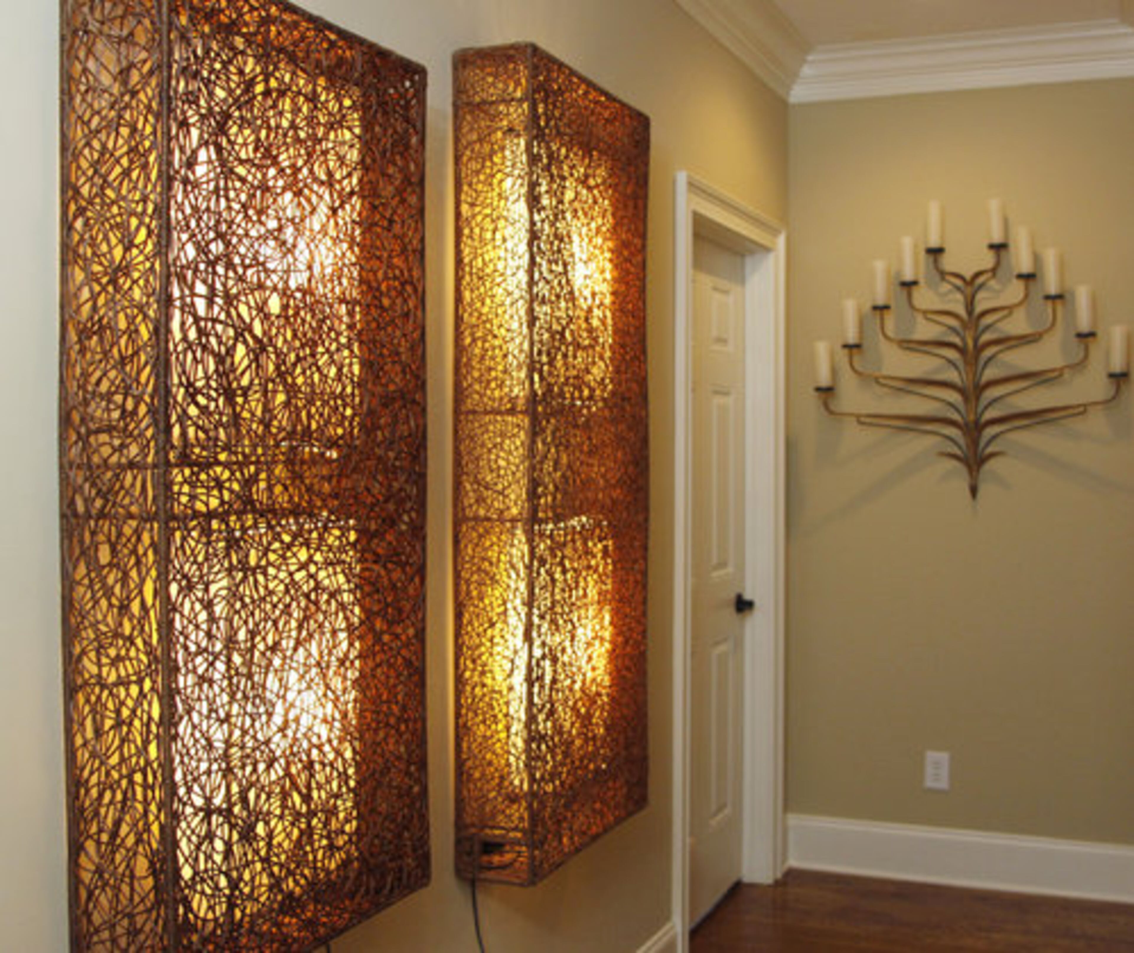 A pair of sculptural panels decorate and illuminate a corridor between bedrooms on the home's second floor.