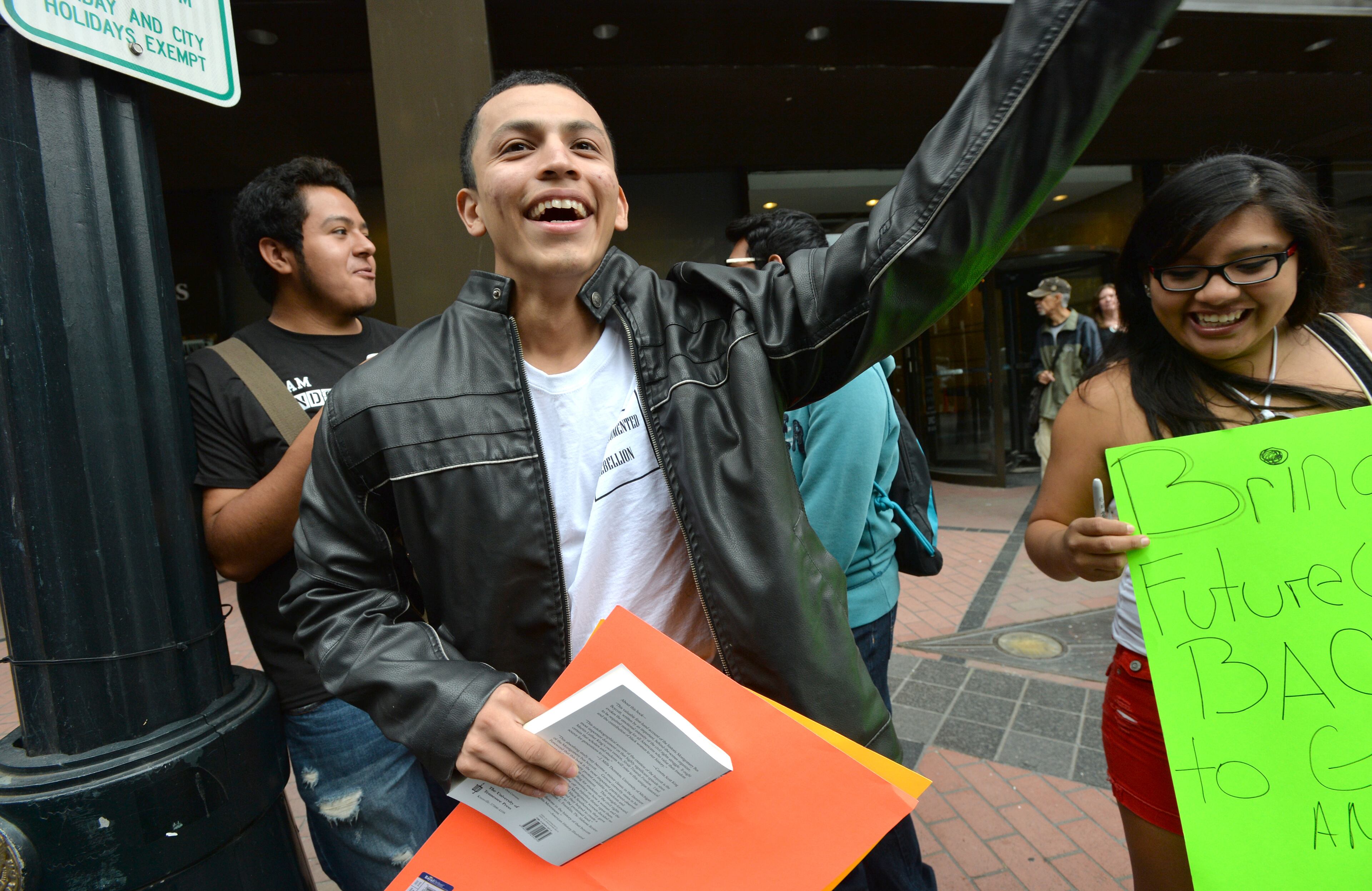 Atlanta - Yovany Diaz (foreground) smiles as he talks with Silvia Carrera (right) as they gather to support Jonathan Zuniga, who is a Dreamer from Buford and left to Mexico after his high school graduation, near Representative John Lewis office in downtown Atlanta on Tuesday, October 15, 2013. Diaz, who was 8 years old at the time, now lives with his mother in Roswell and works at a local discount warehouse store. "It was very dark. The water was cold," said Diaz, who has received a two-year reprieve from deportation. Diaz, who dreams of becoming a social worker, worries the border security legislation could prompt more immigrants to cross dangerous stretches of remote terrain. HYOSUB SHIN / HSHIN@AJC.COM