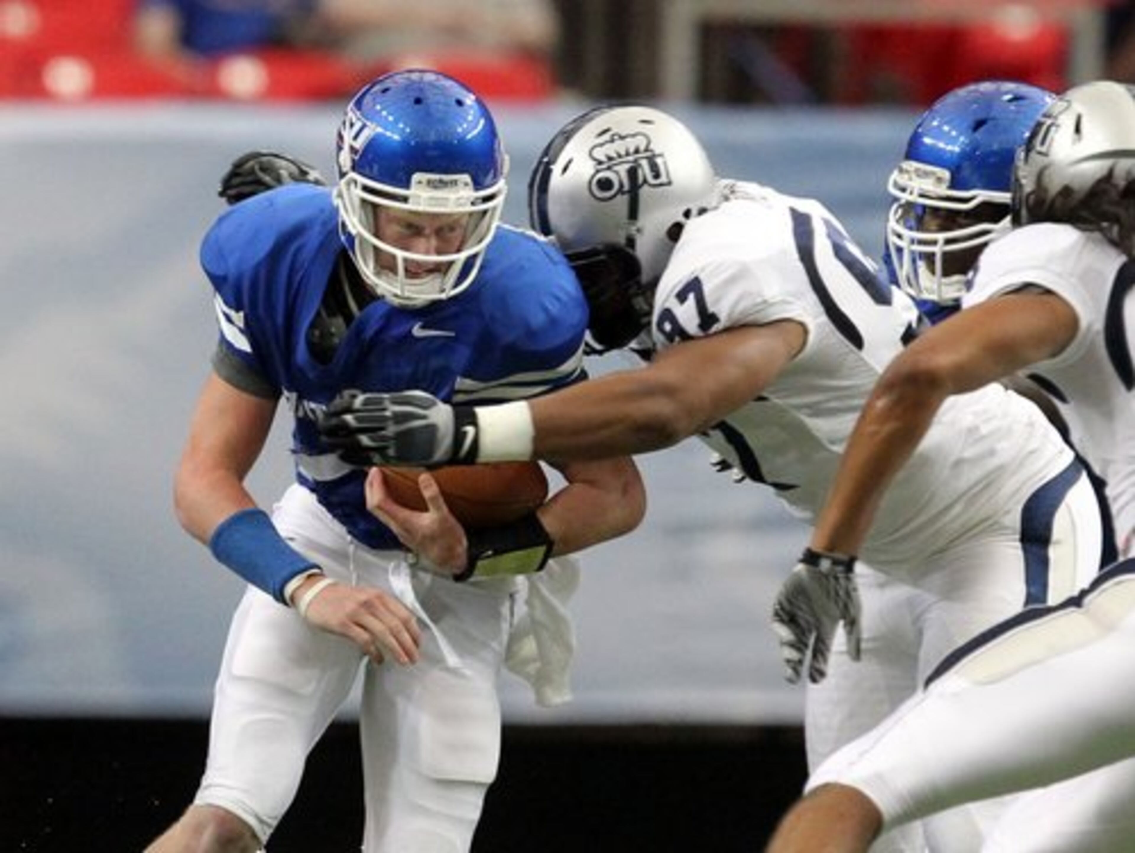 It was rough at times for Panthers QB Bo Schlechter in the first half, here getting tackled by Old Dominion's Edmon McClam ...