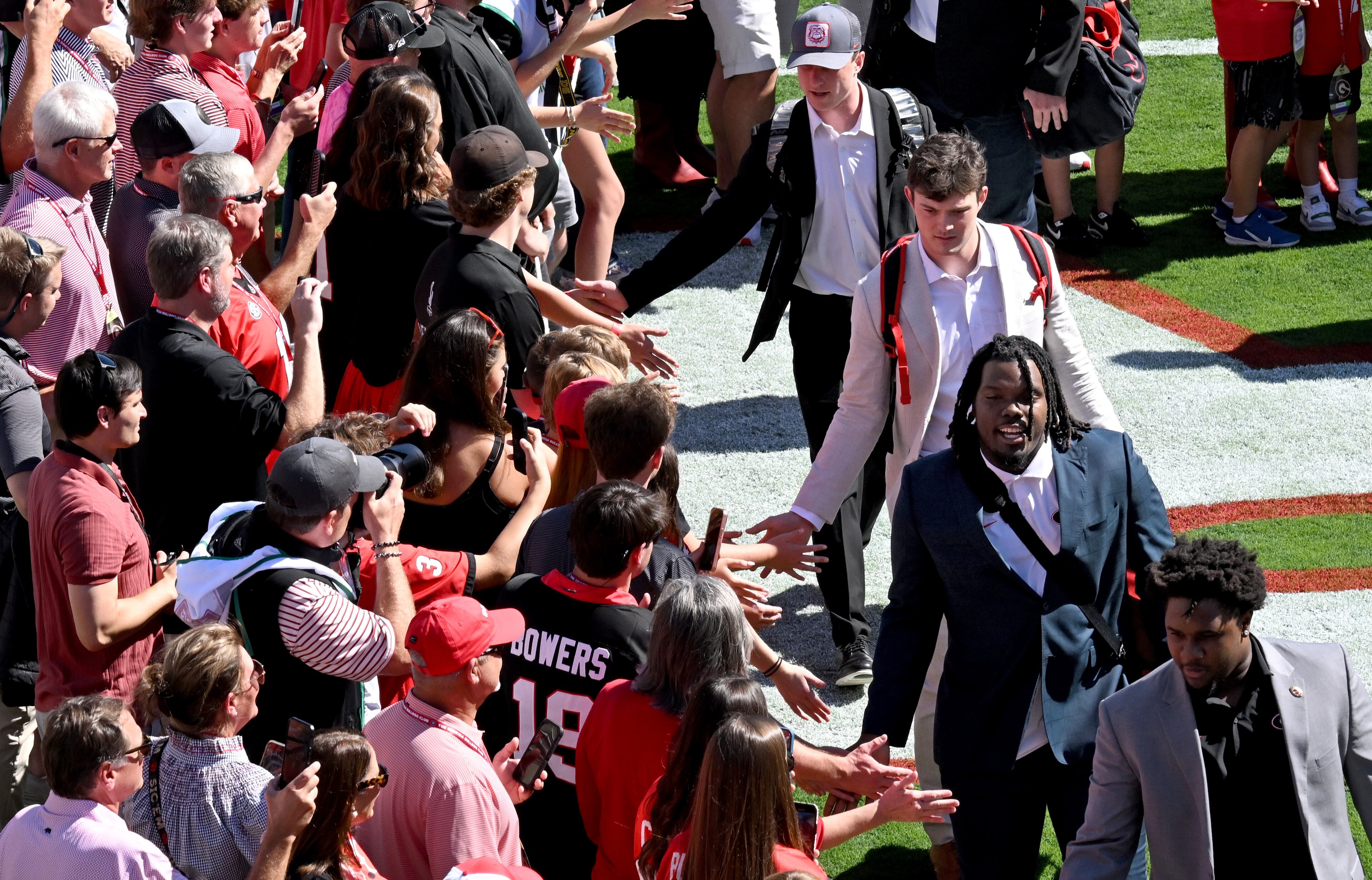 Georgia players and staff arrive during Dawgs Walk before their game against Mississippi State at Sanford Stadium, Saturday, October 12, 2024, in Athens. (Hyosub Shin / AJC)